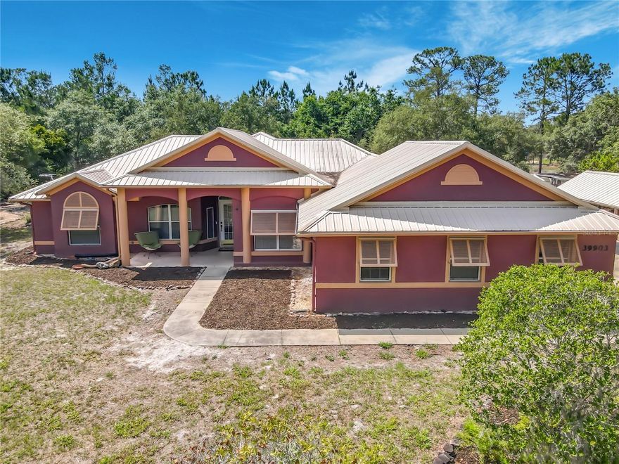 Discover this energy-efficient custom ranch in the desirable Royal Trails subdivision, overlooking a tranquil wetland pond. Built for durability and comfort, the home features thermal-pane windows, a metal roof, Bermuda shutters, an insulated garage door, storm gutters with underground drainage, and 2x6 framing for superior insulation.
The open-concept living area flows into a kitchen and baths finished with granite countertops and custom tilework. Thoughtful trim and built-ins enhance each bedroom, while sliding glass doors open to a landscaped backyard oasis with winding paths, intimate seating areas, and a large covered outdoor living space—perfect for entertaining or peaceful evenings enjoying wildlife.
An extended 2-car garage includes a tiled, cabinet-equipped laundry zone and a workshop with substantial custom storage. Enjoy the balance of serene natural views and convenient access to nearby urban amenities in this well-crafted, move-in-ready home.