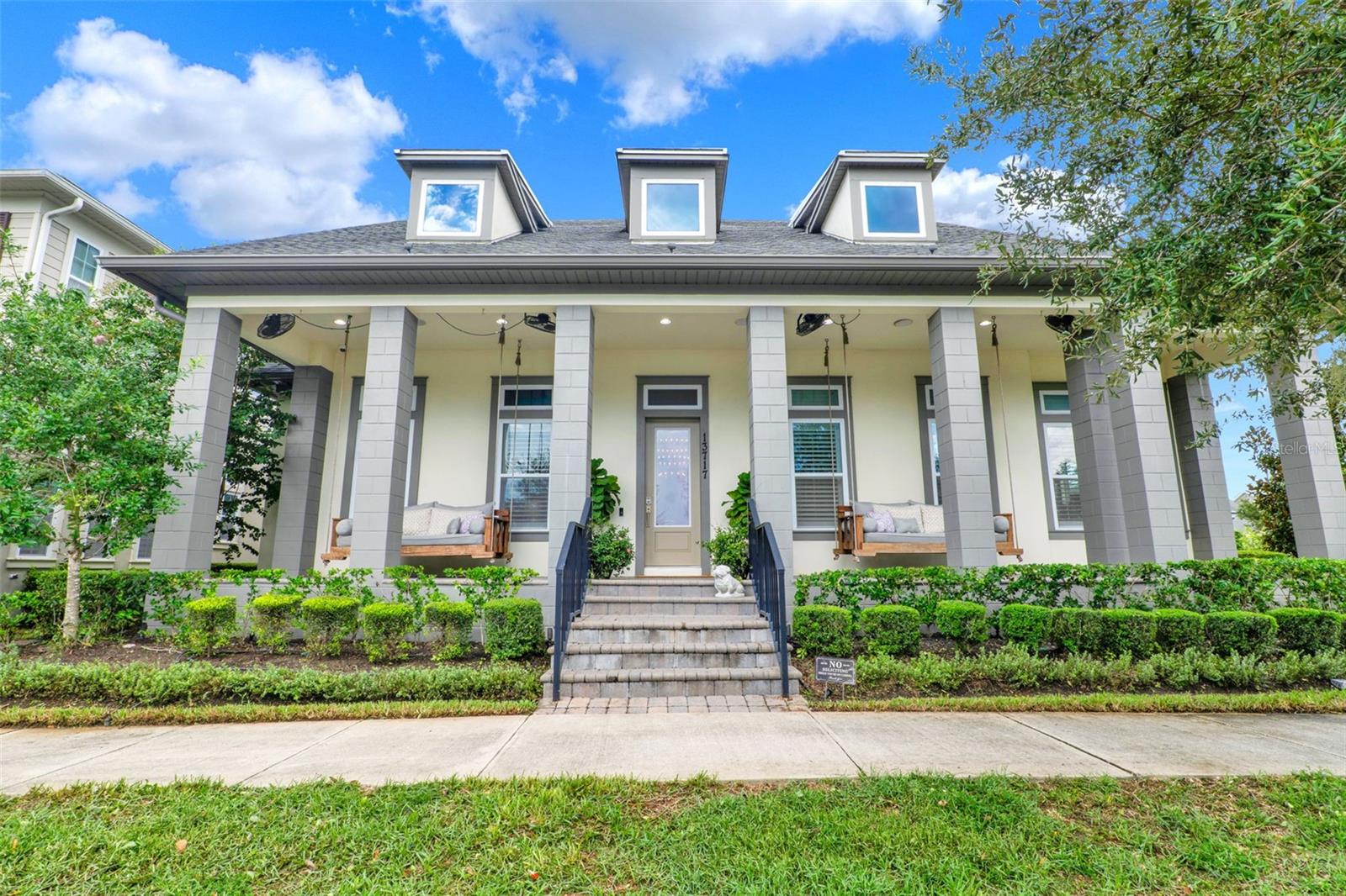 Exquisite Lake Nona Corner Lot Estate with Garage Apartment & Lake Views
Experience refined living in the heart of Laureate Park with this exceptional corner-lot residence, perfectly positioned to overlook the shimmering waters of Square Lake. This thoughtfully designed property offers a rare opportunity to enjoy both a luxurious main home and a private garage apartment.
From the moment you arrive, the home’s inviting curb appeal sets the tone—an expansive, tastefully appointed front porch with two suspended daybed rope swings invites you to unwind while taking in breathtaking sunsets over the lake. Inside, elegance greets you with a dazzling, custom-crafted Swarovski crystal chandelier, setting the stage for the home’s sophisticated style.
The main residence boasts 4 bedrooms, 3.5 baths, a dedicated office suite, dining room, living area, room, and laundry space, all enhanced with high-end designer finishes. The gourmet kitchen is a showpiece, featuring professional-grade stainless steel appliances, striking quartz countertops, and an artfully designed island with a farmhouse sink and dramatic waterfall edge. Natural light floods the dining area through an array of windows, creating a warm, inviting atmosphere throughout the day.
The expansive dual primary suite is a private retreat, adorned with marble flooring, a tray ceiling with mirrored inlay, and an oversized walk-in closet complete with an island, glass-front storage, and a sparkling chandelier. The spa-inspired ensuite offers dual vanities, a premium whirlpool soaking tub with massaging jets, and a generous rain shower.
The open-concept family room flows effortlessly into the sunroom, currently styled as a sitting room but equally suited for a cigar or wine lounge, complete with a bar and beverage refrigerator. Outdoor living is elevated with a fully covered lanai, built-in grilling station, and a resort-style custom pool and spa featuring LED mood lighting and propane-fueled flame accents.
The 3-car garage supports a sleek, one-bedroom apartment with a full kitchen and bath—ideal for guests, extended family, or rental income.
Laureate Park’s exceptional amenities—fitness center, aquatic center, playgrounds, dog park, herb garden, and scenic walking trails—are just minutes from Boxi Park, fine dining, Medical City, Orlando International Airport, and more.
This residence seamlessly blends elegance, comfort, and functionality in one of Orlando’s most desirable communities.
