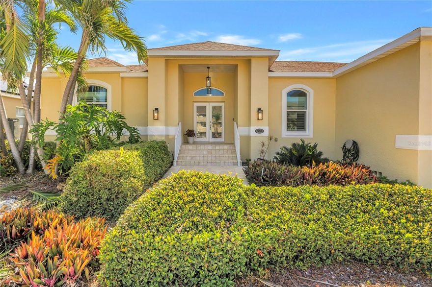 One or more photo(s) has been virtually staged. This premier Tierra Verde property offers a rare slice of coastal paradise, thoughtfully designed for open-concept living and effortless entertaining both indoors and out. With over 2,400 square feet of spacious living, the home features a generous primary suite along with private guest rooms that provide comfort, privacy, and flexibility. The backyard presents a versatile canvas for creating your own private retreat, highlighted by an oversized pool, sun deck, and additional outdoor space ideal for relaxing, entertaining, or everyday enjoyment. Designed for year-round Florida coastal living, the home includes elevated front and back stone patios, impact-rated windows and doors, a wood-burning fireplace for cooler evenings, solar panels, newer HVAC & water heater, a premium water softener system, and newly installed garage door and lighting. Enjoy water views of the Pass-a-Grille Channel from the welcoming front porch, or take advantage of public open-water access at either end of the street—perfect for fishing or sunset views. Tierra Verde is a sought-after coastal community and hidden gem, ideally located between Pass-a-Grille, St. Pete Beach, and the vibrant St. Petersburg city center. Residents enjoy biking, boating, fishing, and a variety of dining options without ever leaving the island. For buyers seeking space, livability, move-in readiness with the opportunity to personalize, and premier coastal living, this exceptional home is not to be missed.