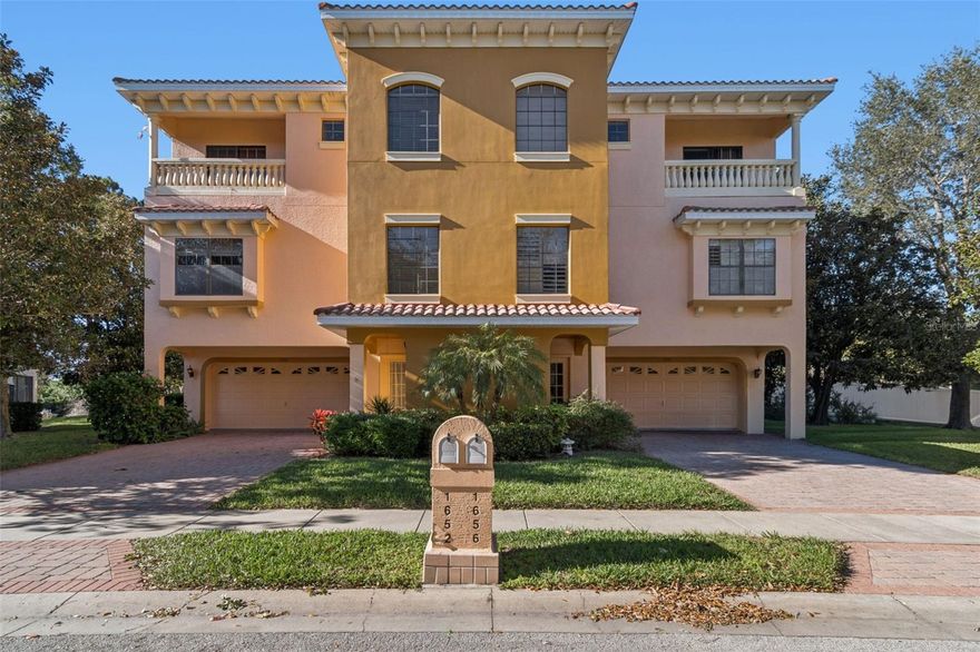 Quality all-block construction with concrete floors on every level, this spacious 3-bedroom, 3-bathroom townhouse is located in the gated Sunset Bay community on a peninsula in Tarpon Springs, just steps from access to the Gulf, where you can launch your kayak or paddleboard and enjoy open-water adventures. The home is designed for storm durability, with no damage from hurricanes in 2024. Featuring an oversized 2-car garage with an abundance of storage space, a private elevator, high ceilings, and an open floor plan ideal for both everyday living and entertaining, this residence showcases a main living area with hardwood flooring and tile throughout. The kitchen offers newer stainless appliances and a large island, perfect for gatherings and meal prep. The expansive primary suite retreat offers a private balcony, ideal for relaxing and enjoying the views. Additional highlights include a concrete tile roof, exterior paint (2025), HVAC systems updated in 2022 and 2016, and a newer water softener (2023). Outdoor living is abundant with three balconies and one patio—three with tile flooring and one screened-in balcony. HOA dues include internet, cable, water, sewer, trash, roof replacement, exterior painting, and lawn maintenance—providing a truly maintenance-free lifestyle. Residents also enjoy access to a heated pool and spa, plus a clubhouse for leisure and social gatherings. Ideally located near the Sponge Docks, historic downtown Tarpon Springs, the Spring Bayou, and popular beaches including Fred Howard Park and Sunset Beach, this home offers the perfect balance of coastal living, peace of mind, and convenience.