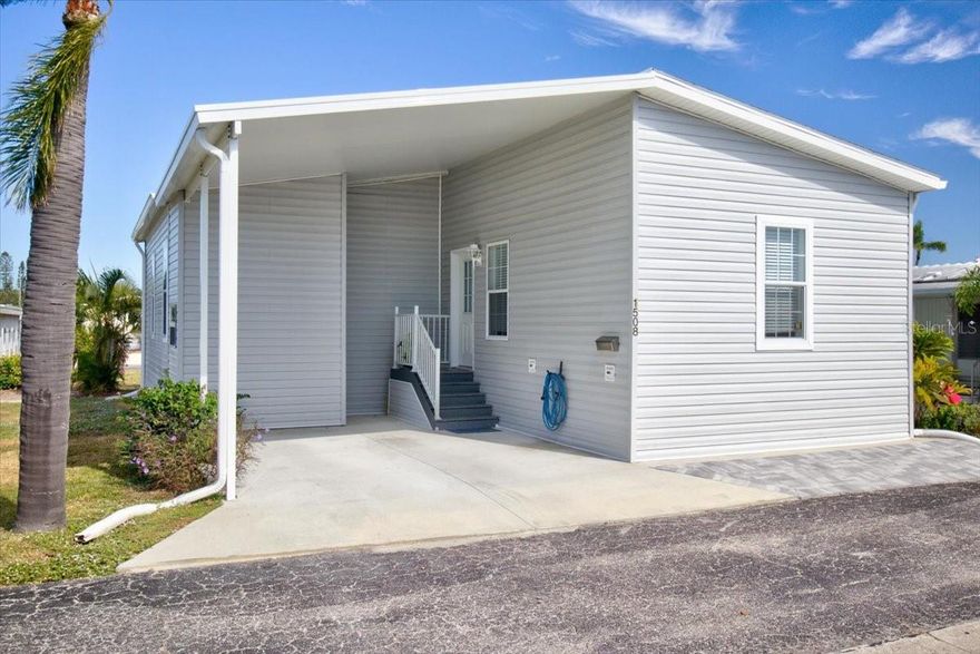 Welcome to Bradenton Tropical Palms, one of the Gulf Coast’s most desirable 55+ co-op communities, perfectly positioned just minutes from Florida’s world-famous beaches and the vibrant energy of downtown Bradenton. This exceptional 2023 Jacobsen double-wide home offers the ideal blend of modern comfort, thoughtful upgrades, and bright, open living spaces that radiate coastal charm from the moment you walk through the door. High ceilings and beautiful LVP flooring create an airy, inviting atmosphere throughout, while the open-concept living, dining, and kitchen areas fill with natural light, making the home perfect for both effortless entertaining and peaceful everyday living. Designed for convenience and longevity, this move-in-ready home features two spacious bedrooms and two full baths, with furnishings negotiable to suit your personal style. A covered carport and storage shed add further convenience, accommodating vehicles, a golf cart, and outdoor essentials with ease. With a motivated seller and pricing designed to move quickly, this home is an exceptional find. Life at Bradenton Tropical Palms is truly unmatched, offering a resort-style experience in a warm, welcoming setting. Residents enjoy access to a 60' × 40' heated pool, a relaxing hot tub, a professional fitness center, a library and activity center, and a large meeting hall that seats 300 and features a full stage for community events. The community also boasts 22 shuffleboard courts, indoor air-conditioned pickleball, a butterfly garden, a shaded gazebo, a beautiful memorial garden, and impeccably landscaped walking paths. With year-round social events, dances, classes, and activities, it’s easy to build friendships and stay active. The location is equally impressive—just minutes from Anna Maria Island’s pristine beaches, top-rated restaurants, shopping, nature preserves, and more than 35 golf courses within a 15-mile radius. Sports enthusiasts will love the short walk to LECOM Park, the spring training home of the Pittsburgh Pirates. Surrounded by beautiful landscaping, peaceful streets, and friendly neighbors, this home offers far more than just a place to live—it offers a lifestyle filled with comfort, connection, and endless opportunities to enjoy the best of Florida’s Gulf Coast. With its modern design, extensive upgrades, incredible amenities, and unbeatable location, this is the perfect home for buyers seeking relaxation, convenience, and community. Opportunities like this rarely last, so don’t hesitate—your next chapter in paradise awaits.