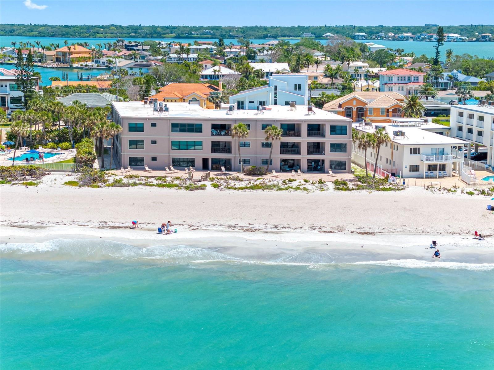 Belleair Beach charm and idyllic oceanfront setting pair beautifully in this wonderful beach home. Situated in a perfect location on Belleair Beach, this updated first floor unit offers exceptional beach living without the hustle and bustle of larger high-rise properties. The floor plan is open and features gorgeous luxury vinyl flooring that flows throughout, well designed open kitchen with custom wood cabinets, freshly painted walls, and abundance of natural light that adds to the beachy ambiance. The bedrooms are split for privacy and the owner's suite features a walk-in closet and EnSuite bath. Sliding doors open to a tranquil patio and courtyard for relaxing outdoors and there is storage as well. Want to generate income when you are not enjoying the property? Belleair Sands has a 1-month minimum rental policy that makes this an outstanding investment property as well! Enjoy magnificent sunsets from the community terrace that overlooks the Gulf and explore one the most pristine stretches of sand anywhere. Belleair Sands is a well-maintained boutique style property that is private and serene yet super close to exceptional dining, shopping, entertainment, and the Jolley Trolley! Milestone report and SIRS both completed and available. Room sizes are approximate. Call now to Schedule your tour. Virtual tours are also available.
