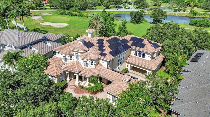 (IMPORTANT) ***Please watch the home tour video.*** With a recent appraisal surpassing $2,500,000 and over $300,000 in recent updates, this outstanding residence is priced to captivate discerning buyers, promising a limited opportunity to own a piece of elevated living.  Accessible 1st level luxury with master suite, kitchen, and living areas on the first floor, supported by an elevator for convenient access to the second floor.  Designed for ultimate entertaining, with expansive remodeled kitchen, doors opening to a pool oasis, and a versatile game room/theater combo for hosting gatherings. Crafted for sustainable living with 72 solar panels, EV charging, and remarkably low electric bills for a 6700 sqft home.  Seamlessly integrated living, kitchen, and pool areas ensure you never miss a cherished moment with family and friends.  Step into a harmonious residence designed to enhance connection and celebrate life's precious moments. Picture a home where the living area, kitchen, and pool are seamlessly intertwined, ensuring you're always present for every laugh, conversation, and celebration. This narrative of luxury and practicality continues upstairs, where a versatile game room/theater combo invites leisure and entertainment. Imagine the delight of relishing vintage arcade games or immersing yourself in cinematic marvels. A full gym with over $15,000 of gym equipment conveys with the home in the 3rd garage, making healthy living an easy daily convenience.  Cultivate the mood of your day with a crisp, strong, sound from Sonos speakers throughout the home.
Outside, a pebble-finish pool, hot tub, and fountains create a serene outdoor haven.  Elevated views from the expansive balcony provide incredible ways to enjoy nature and outdoor living. These features, coupled with the solar panels, underscore a home that seamlessly merges opulence and eco-consciousness.  
Nestled within the legendary Bayou Club community, this residence offers more than just a home; it embodies a way of life. Situated conveniently near world class beaches and vibrant thriving cities, it marries luxury and functionality in perfect harmony. Your personal invitation to explore this exceptional dwelling awaits – reach out now to secure your private tour.