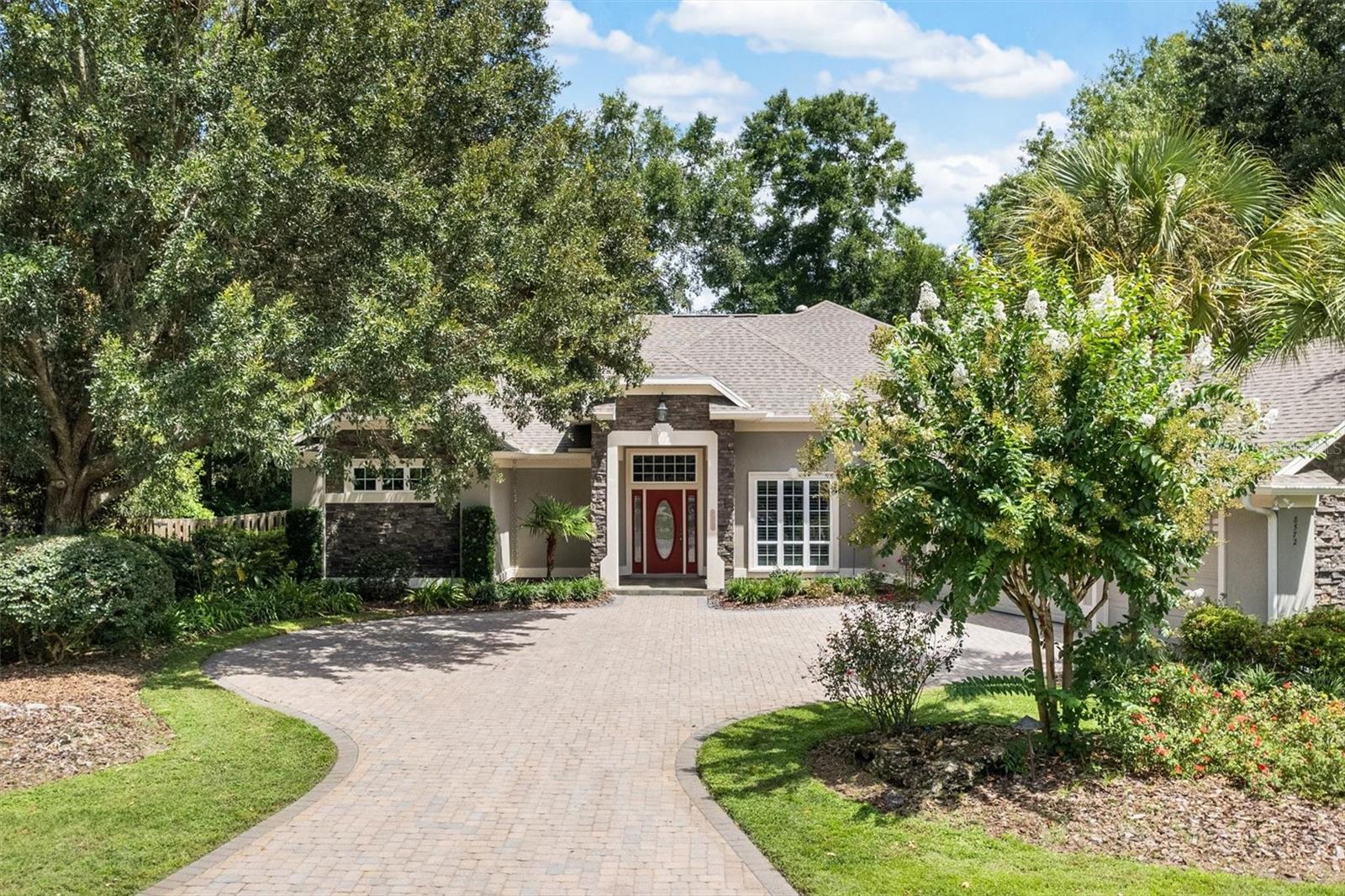 Welcome to this stunning, impeccably maintained, 4/3 executive pool home, tucked away in the Braemar neighborhood of Cobblefield. Situated on a beautifully manicured property, this home is a beauty….exceptional curb appeal accentuated with lush landscaping, paver driveway, and an elegant, stacked stone entryway. Step inside to abundant natural light and beautiful, natural bamboo flooring throughout the main living spaces. Inviting you into the home, the dining room and living area are perfect for entertaining guests or hosting family gatherings! The heart of the home is a chef-inspired kitchen created by Haile Kitchen and Bath, featuring: Expansive breakfast bar, stainless steel appliance suite, instant hot water faucet, custom wood cabinetry with TWO built-in pantries, a coffee station, appliance storage, stone countertops AND full backsplash. The kitchen flows to the great room/family room; the chef won’t miss any of the action! There is an informal dining/breakfast nook and Plenty of of room for flexible furnishing arrangements. The three-way, split floor plan offers privacy and flexibility: The luxurious primary retreat occupies one wing, with direct access to the pool and lanai. This bedroom opens to the two custom closets, certain to delight the most discerning, fashion-forward owners! The bath is spacious, featuring dressing table, dual vanity and sinks, and oversized shower. A private water closet completes the package. Two spacious bedrooms and bath are located in the second wing. The fourth bedroom, third bath, and a large media room are tucked away in the third wing—ideal for guests, families, or multi-generational living.
The media room is an entertainer’s dream, featuring a custom, built-in entertainment center with variable lighting, an electric fireplace for ambiance, an adjustable, custom TV mount system, even a wet bar with granite countertops and a wine/beverage fridge. Family and friends will LOVE this space! The media room opens directly to your own private backyard oasis. Enjoy the pool and spa, waterfall feature, and multiple lounging and dining areas! The yard is fully fenced with two separate areas, perfect for pets or play…custom landscape lighting is wonderful for your evening enjoyment. Additional highlights of this home include a 3-car garage with mini-split A/C and insulation to enjoy your hobbies, baby your vehicles, house your Toys, or to take advantage of its climate-controlled, abundant storage.
This home truly has it all—luxury, functionality, and the perfect layout for everyday living or entertaining! New roof in 2022, new HVAC 2025; move in and enjoy Florida living at its Best!
