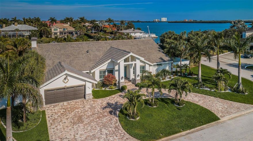 LOCATED ON A LARGE LOT IN ELEGANT, UPSCALE BAYWAY ISLES, THIS MAGNIFICENT AND INSPIRED TOP-TO-BOTTOM REDESIGN IS A TRANSFORMATION OF A 4000 SQFT, 5 BEDROOM, 4 1/2 BATH, SPLIT BEDROOM ARTHUR RUTENBURG WATERFRONT HOME THAT DELIVERS AN EXTRAORDINARY COASTAL FLORIDA LIVING EXPERIENCE! Beyond the lush landscaping, fine circular drive and rich covered double door entry, you’ll be welcomed to a home with tall beautiful ceilings, elegant flooring and superb finishes throughout. A splendid open living area and dedicated executive office suite, are complemented by a posh formal dining area. The sumptuous chef’s kitchen boasts luxury appliances, gorgeous granite surfaces, custom-built cabinetry, breakfast bar and fine casual dining overlooking the pool deck and waterfront. The massive family room includes a lovely fireplace, a plush built-in wet bar and 11ft-high beamed ceilings. Spacious and grand owner’s suite provides a large sitting area overlooking the pool deck and a sizable walk-in closet with closet system. Pamper yourself in the truly luxurious owner’s bath. All bedrooms are sizable, with a pleasing, satisfying appeal and all baths have elegant luxury finishes. Living room enjoys multi-panel sliding glass doors that pocket to create a tremendous indoor/outdoor entertaining environment. Huge 2200+ sqft screen enclosed pool deck overlooks the open bay. This home is virtually brand new with great attention paid to quality workmanship and lavish materials and details - with updated electrical, updated plumbing, updated fixtures, updated bathrooms, updated kitchen, updated A/C, newer roof, newer tankless hot water heating, newer hurricane impact windows & doors, newer pool/spa, newer pool deck & screen enclosure, and so much more! Step out to your back yard and be taken in by a beachy, tropical oasis unlike any home in the area! Terrific powder soft sands, generously placed Coconut Palms and fabulous subtropical vegetation deliver a fantastic Caribbean beach vibe! Updated dock and boat lift offers rapid access to the intracoastal waterway and the Gulf. A wonderful, worry-free home, and a great value in a fantastic location. Almost perfectly located – just 5 min to St. Pete Beach, 10 min to downtown St. Petersburg and 25 min to Tampa International Airport.
