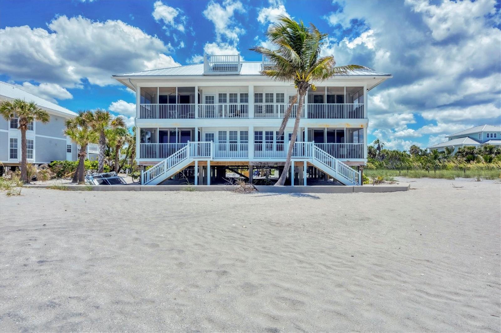 This without a doubt is the MOST SPECTACULAR 2-bedroom 2-bathroom villa with unobstructed coastline views on beautiful Palm Island! Within a few steps of exiting your beachfront lanai you're on the beach basking in the sun, collecting seashells and shark teeth, and watching the dolphins and manatees play. The beach is so quiet and quaint it will feel as if you are the only one living on Palm Island. Entertain your friends and family from your back porch and watch the amazing colorful sunsets that can only be seen from your covered screened in lanai. The long miles of beach views are endless from your primary bedroom, dining room, kitchen and covered lanai. This 1232 square foot home comes completely furnished and has had recent major improvements including: new AC unit installed (2021), new quartz countertops and stainless steel sink in kitchen (July 2022), new granite bathroom countertops and sinks (July 2022), freshly painted cabinets in both bathrooms (July 2022), new paint throughout the entire villa (July 2022), NEW flat screen televisions in ALL rooms including family room (60” inch) and both bedrooms (2022) , new fans installed throughout entire unit (July 2022), new sea turtle approved roller shade in family room (September 2022), new hot water heater (2022) and a NEW ROOF . The villa has been recently redecorated (July 2022) and can also be used as a rental within Palm Island Resort if so desired. This home has bamboo floors in the main living areas with tile in the kitchen and bathrooms. There is a comfortable king-sized bed in the primary bedroom with private en-suite and dual built-in closets. The second bedroom includes two twin-sized beds with built-in closets. Two additional closets within the unit provide ample space for any extra pool/beach accessories. The kitchen has slow-close cabinets and is fully stocked for all your cooking needs. The laundry room with a stacking washer/dryer, mini fridge, storage cabinet, and sink and window with beach view, so makes doing laundry FUN! Extras outside the villa is a outdoor shower, two-foot showers, and deck box to hold beach chairs and beach canopies. This golf cart only friendly island includes a community pool, restaurant at Palm Island Resort (Rum Bay), tennis courts, spa/workout center, boat docks, 24-hour security, and many other amenities to be enjoyed! A short ferry ride is all it takes to get to this incredible private oasis. No matter where you are on Palm Island, you will never regret owning this little piece of paradise.