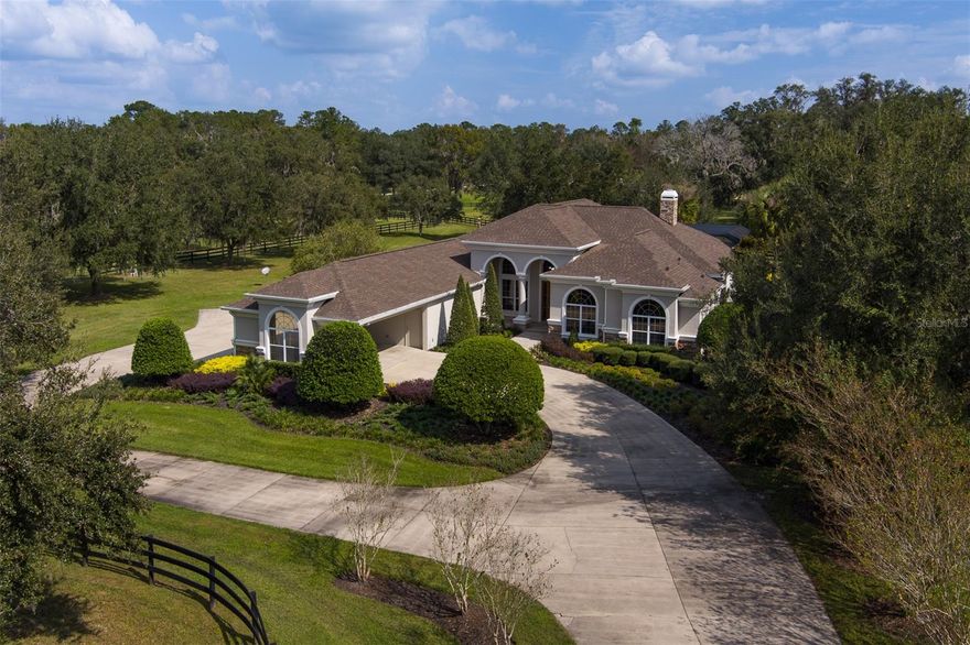 Situated on 21+ acres in Brookfield Annex, Reddick, FL, this meticulously maintained equestrian property is under 15 minutes from both the World Equestrian Center and HITS. The circular drive leads to a portico and 2-car garage, welcoming you to a spacious 4-bedroom, 4.5-bathroom home with high ceilings and tile flooring throughout. The master suite and guest suites provide ample comfort, while the family room opens to a screened-in pool and outdoor living area, ideal for entertaining. The landscape, dotted with majestic live oaks, includes a tranquil pond that adds to the property’s natural charm. Equestrian amenities feature a round pen and an 8-stall block barn with a feed/tack room, along with an upstairs guest or farm manager’s quarters with 2 bedrooms, 2 bathrooms, and a screened porch overlooking the pond. A 5-bay equipment garage offers extensive storage options.