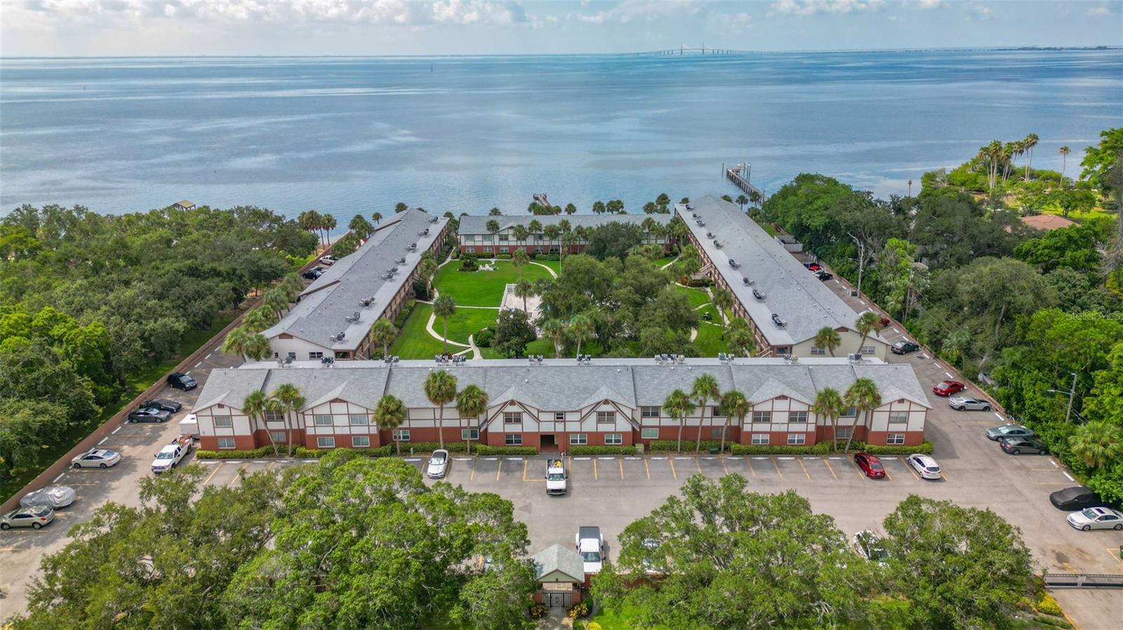 Welcome to 650 Pinellas Point Dr S, Unit #218 — a well-appointed 2-bedroom, 2-bath condo located in a desirable 55+ gated waterfront community in St. Petersburg, Florida. This residence features a bright and open floor plan with partial water views, a functional kitchen with ample cabinetry, and spacious bedrooms designed for comfort and convenience. The primary suite includes an ensuite bath and generous closet space, while the second bedroom offers a Murphy bed, providing flexibility for guests or a home office. Additional conveniences include laundry facilities on the same floor as the unit, a separate storage space, and assigned parking. Residents enjoy access to a variety of resort-style community amenities designed for leisure and recreation. Perfectly situated near Tampa Bay waterfront parks, award-winning Gulf Coast beaches, downtown St. Petersburg, dining, shopping, and cultural attractions, this property is an excellent opportunity to enjoy the Florida coastal lifestyle in a secure, maintenance-free setting.