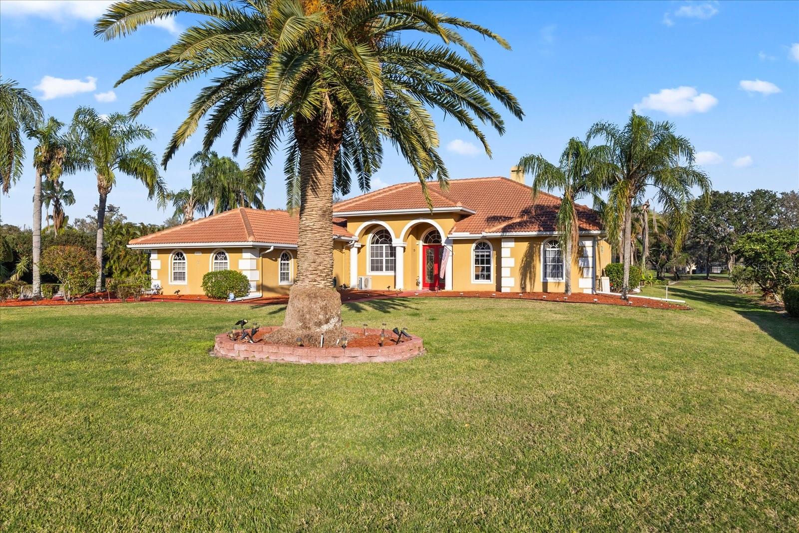 Discover a River Club estate that truly stands apart from the uniform homes found in Lakewood Ranch. Set on nearly an acre along the 3rd fairway of the River Club’s public golf course, this custom-built residence offers privacy, space, and unique architectural character throughout. Soaring 15-foot ceilings, marble floors, and a thoughtfully designed floor plan create a sense of elegance and openness from the moment you enter. Unlike many newer communities, this home delivers elbow room both inside and out—with expansive green views, no direct rear neighbors, and generous side yards. The outdoor living space is ideal for entertaining, featuring a large heated pool and spa, outdoor kitchen, solar landscape lighting, and a full-screen enclosure. Major updates have already been handled, including a new barrel tile roof (2021), water heater (2024), A/C (2021), and pool heater (2023). A full-house generator and propane service add year-round peace of mind. Inside, the chef’s kitchen includes a gas cooktop and walk-in pantry, while a split-bedroom layout ensures privacy for owners and guests. The oversized four-car garage and extra-long driveway offer ample space for vehicles, golf carts and more. Ideally located just minutes from Lakewood Ranch, Waterside Place, Sarasota-Bradenton Airport, top-rated schools, and an array of shops and restaurants, this home also benefits from no CDD fees and a low HOA. This home combines luxury living with smart long-term value. If you're looking for a truly distinctive home with more land, more style, and more freedom, this River Club gem is a must-see.