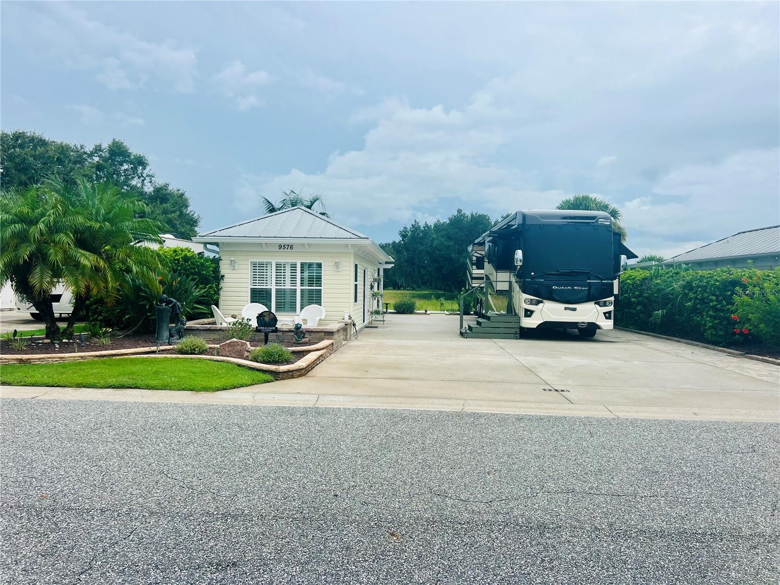 Discover resort-style living on this east-facing back-in lot with 5,076 sq. ft. of beautifully
designed space in Florida’s friendliest motorcoach resort! This property features a 26’x76’
reinforced concrete pad with full hookups for your Class A or Super C motorhome, plus
thoughtful upgrades throughout.
Enjoy your mornings on the welcoming front porch, perfect for watching sunrises, accented by
a low-maintenance flower bed that gives this lot wonderful curb appeal. Pavers line the pedestal
side, while a pergola defines the back living space, surrounded by professional landscaping
that highlights the serene pasture views. Extra concrete behind the Grande Suite adds valuable
storage options.
The 384 sq. ft. Grande Suite, remodeled in January 2024, offers stylish comfort and
functionality. The L-shaped kitchenette is a showstopper, boasting storage galore with rich
cabinetry, a stunning granite countertop, and crisp white subway tile backsplash. The beadboard
ceiling adds charm and elegance, while plantation shutters bring warmth to the living room.
This fully furnished suite includes a full bath with a walk-in shower and glass doors, a
dedicated laundry room with washer/dryer and refrigerator, plus extra storage to keep
everything organized.
Florida Grande isn’t just a resort—it’s a lifestyle. Owners enjoy access to a 20,000 sq. ft.
clubhouse, 8 brand-new pickleball courts, dog park, pool and spa (both resurfaced this
summer), and a vibrant calendar of activities. From card games, line dancing, trivia, and bingo to
dinners, happy hours, food trucks, and special events—you’ll never run out of ways to connect
with new friends.
Ideally located in the heart of Central Florida, the resort is just an hour to Tampa, Orlando, and
Ocala, making it the perfect home base to explore all that Florida offers.
Don’t miss your chance to join this incredible community—schedule your showing today and
start living the Florida Grande lifestyle!