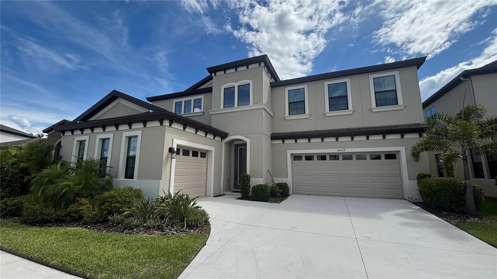 Ultra spacious 5 bedroom 4 1/2 bath home located in the highly desirable community of Hawkstone. This almost new (2021) "Belmar" model built by Homes by WestBay boasts an incredible 4,295 square feet of living space. This home is sure to impress with its two-story volume ceiling in the foyer, an office/den and another flexible space perfect for a second home office or a formal dining room. The expansive combination island kitchen, great room and cafe open to the oversized lanai for seamless indoor and outdoor living. Downstairs bedroom and full bathroom is perfect for guest room or mother in law suite. Upstairs is the unbelievable owner’s retreat complete with huge walk-in closet and spacious bath with dual vanities, garden tub, and separate shower. Also upstairs are 2 bedrooms joined with Jack and Jill bath, additional bedroom and bathroom, laundry, MASSIVE bonus room, and balcony accessible from bonus room and master bedroom with sweeping pond and backyard views! Home features a separate 2 car and 1 car garage as well as a fenced backyard! Hawkstone amenities include a resort style swimming pool, playground, dog park, and more!