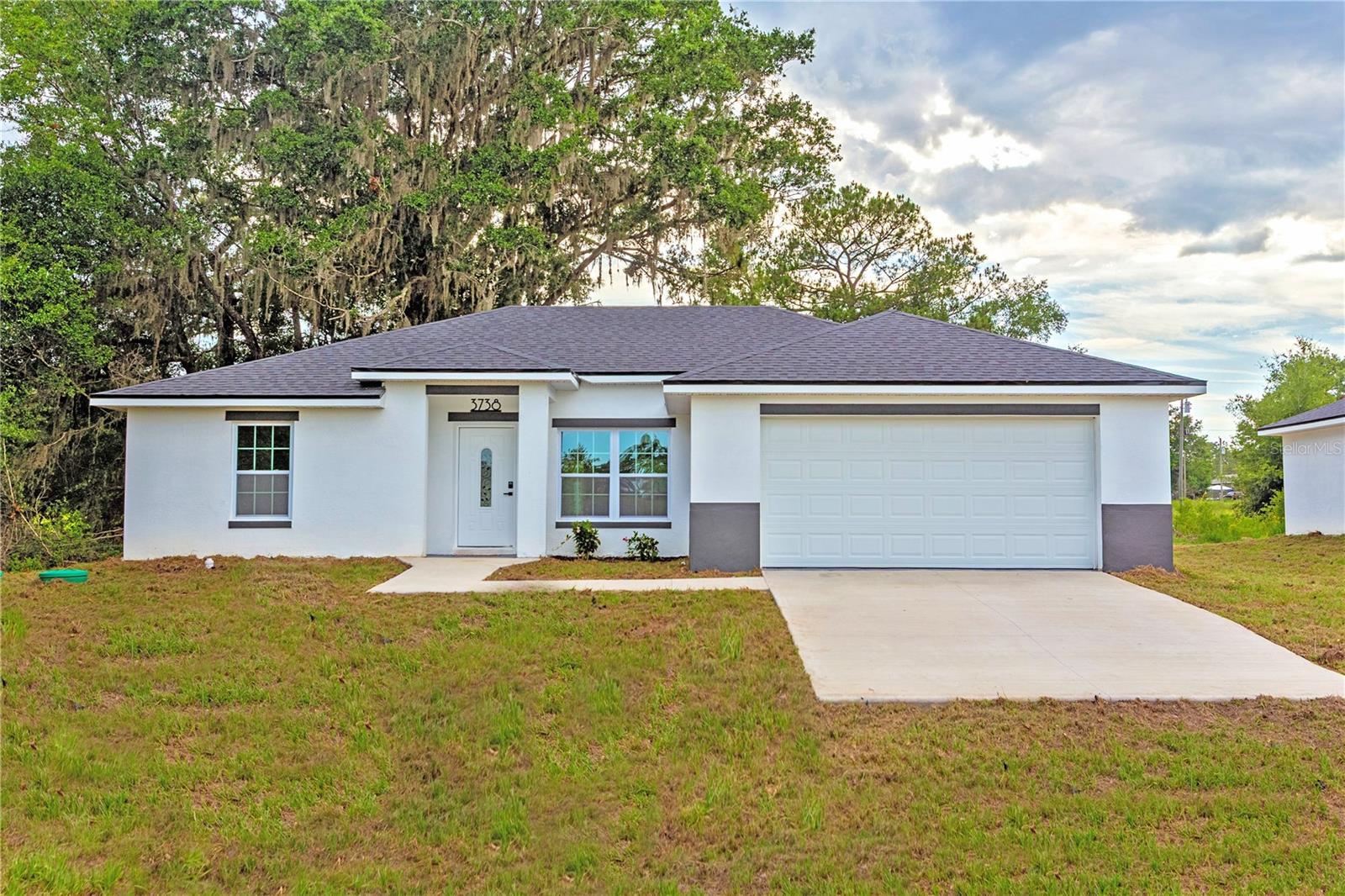 MOVE IN READY__No HOA___ This is a Stunning, Modern 3/2 with over $15k in upgrades and is located 13 minutes from World Equestrian Center (Block construction) ** Builder offers extended 2-10 warranty. The kitchen features solid Shaker wood cabinets, soft close, Quartz Island, European Modern Faucets, beautiful backsplash & Modern finishes, stainless steel appliances, pantry, and a beautiful dinning area that overlooks the backyard nature through the window. WATERPROOF Luxury vinyl plank floor throughout all the home. ***The Master bedroom offers lots of space with tray ceiling and a Large Walk In Closet. Beautiful shower with Rain Head & European drain. His and hers vanities (with Waterfall Faucets & Quartz conters) give extra space to the buyer with SMART anti fog/light up rounded Mirrors. Separate toilet room. The other side of the home features 2 guest bedrooms with large windows, guest bath with tub/shower with European Waterfall Faucets and linen closet. Large inside laundry room and 2 extra storage closets on the hall for the family needs. All throughout the home you have upgraded light and plumbing fixtures. The covered front and back patio invite to enjoy the quiet of this neighborhood. 2 car garage. Stunning backyard for all your entertainment or storage needs. Home is ready for your family and all your toys. Ride the ATV through the neighborhood, park the rv, close to Supermarkets, Restaurants , WEC, HITS, Rainbow River and more.