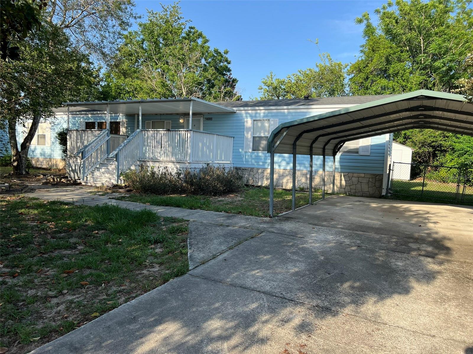 LARGER PRIVATE HOME IN COMMUNITY WHERE YOU OWN THE LAND AND NO HOA! SEE THIS SPLIT BEDROOM HOME WITH PRIVACY FROM THE ROAD AND TWO COVERED DECKS TO ENJOY! PROPERTY FEATURES A FENCED BACK YARD, OUTDOOR SHOWER HOOKUP, SHED, AND LARGE 12' BY 32' COVERED SCREEN ROOM. LARGE CARPORT AND COVERED DECK IN THE FRONT GREETS VISITORS. THE HOME HAS A SPLIT BEDROOM PLAN, LAUNDRY IN A KITCHEN CLOSET, AND A LARGE PRIMARY BATHROOM WITH SHOWER AND GARDEN TUB. SEE THIS HOME FOUND IN SUMMERFIELD AND MAKE IT YOUR OWN!
