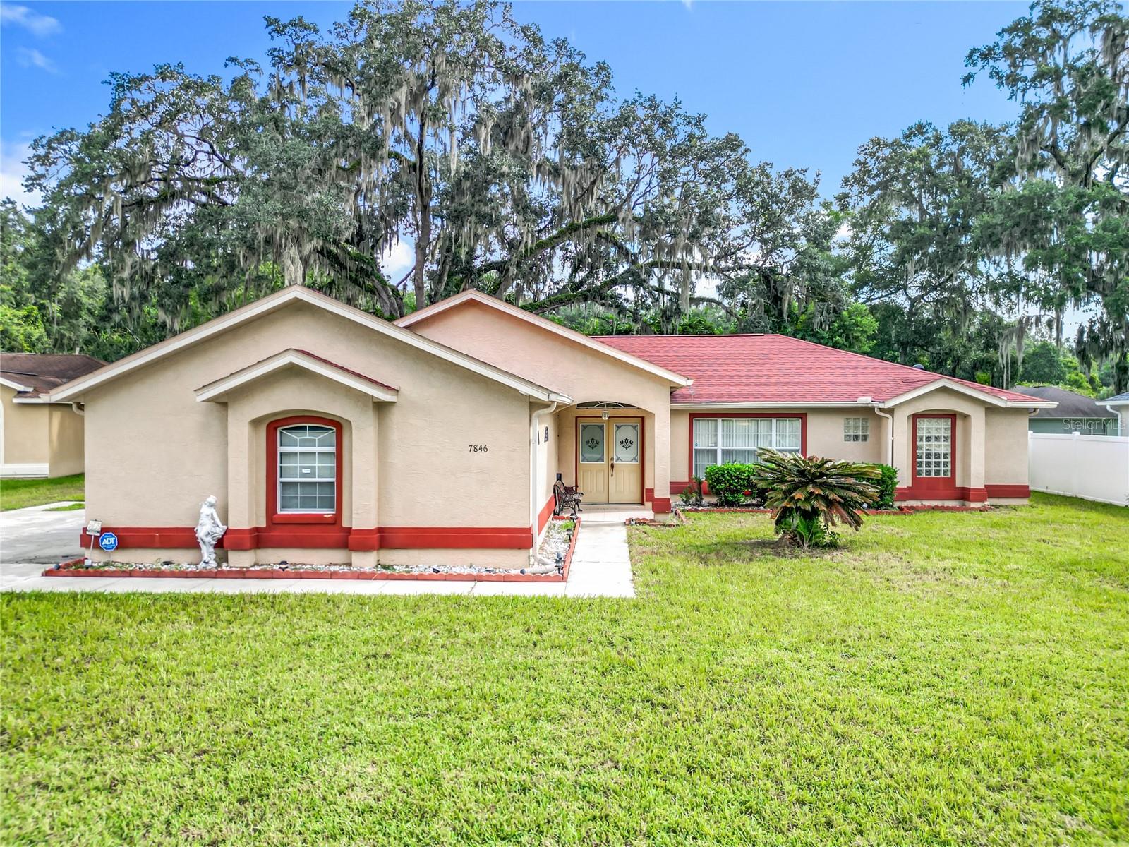 Looking for your next home in the desirable Hidden Lake community? This home features 3 bedrooms and 2 baths on just over a quarter of an acre. The split bedroom floorplan layout makes entertaining with family and friends a breeze! The light and bright airy kitchen boasts a large pantry closet, plenty of cabinetry, and a breakfast bar that opens to the dining area. Between the garage and the kitchen is an oversized laundry room that you can use as a mud room or simply as extra storage space. The spacious master has a large walk-in closet and a private ensuite bath featuring a walk-in shower, a separate garden tub, and dual sinks. Bedrooms 2 and 3 are conveniently situated on either side of the second full bath. There is an attached 2 car garage and a long drive offering ample space to park multiple vehicles. You will absolutely love the covered lanai on the back of the home with a private, wooded backdrop, adding almost 300 additional SF of serene living space for your year round enjoyment. Your new home also boasts a newer roof installed in 2023 ensuring peace of mind for many years to come! And the home is in "X" flood zone, the most desirable there is! Conveniently located near top-rated schools, shopping, dining, and recreation, with easy access to I-75 and Marion County’s stunning natural springs and parks including Silver Springs State Park and the Ocala National Forest. The World Equestrian Center hosts horse shows, dog shows, car shows, entertainment, conventions, lodging and various eateries. Quick closing is possible, and buyer should confirm all room measurements.