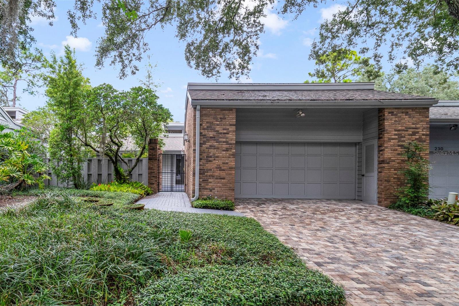 Light and bright single story townhome in Whispering Pines in the gated Springs community situated on a cul-de-sac. Three spacious bedrooms, two baths, open kitchen with combined family/gathering room, separate eating area in kitchen, dining room and living room with wood burning fireplace and wood flooring. Two-car garage has removable access ramp. French doors throughout. Front courtyard is gated and has a nice deck area. The rear fenced yard has ample room for gardening, fruit trees, and a covered screened patio as well as a screened patio off the master bedroom. Roof replaced, exterior painting, new gutters with leaf guards installed, new exterior and interior breaker panels installed in 2023. New insulation and pavers in 2024. New stove in 2025 with dishwasher and disposal replacement in 2023. Skylights also replaced. Kitchen door/windows replaced in 2025. Whispering Pines has a community pool AND tennis court. The master association has a natural spring and beach area, playground, recreational facilities, and clubhouse.