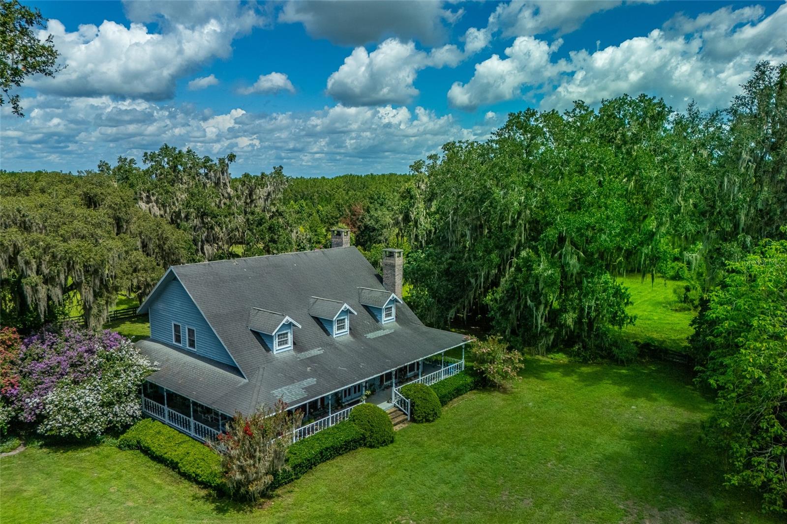 **PRICED FOR QUICK SALE**Exceptional Investment Opportunity! Located in the well known NW Marion County area, this property is 25 minutes from the World Equestrian Center, Ocala Breeders Sales, and the Ocala Jockey Club.
Beautiful pastures and grand oaks on almost 40 acres of pristine Marion County soil, a custom 3-bedroom, 2.5-bath residence with character and craftsmanship, a welcoming covered three quarter wrap around porch to enjoy morning views and a covered breezeway that connects to the Two story cottage/garage that can be converted to apartment, office, hobby room, or extra storage it has the electrical and water connections on place.
A semi-open layout, hardwood floors spacious kitchen and center island, a cozy breakfast nook with bay windows offers a peaceful spot to enjoy morning coffee with peaceful views, just off the kitchen, the family room invites relaxation with a fireplace and slice doors that open to the patio for seamless indoor-outdoor entertaining, formal dining room and Fireplaces in living room, family room, and master bedroom, balcony off master bedroom. All windows and sliding doors have double-paned, impact-resistant glass.
The facilities include A 7-Stall barn with foaling stall and feed/tack room, it needs work and a new roof also has a laundry room and One bedroom barn apartment with kitchen, bath and living room-Paved driveways-Yard fully fenced for dogs-Seven paddocks and pasture-Automatic waterers-Two entrances-Two wells.
The Property needs some TLC in general and new roof, priced accordingly and and so much potential.
Call for a private tour.