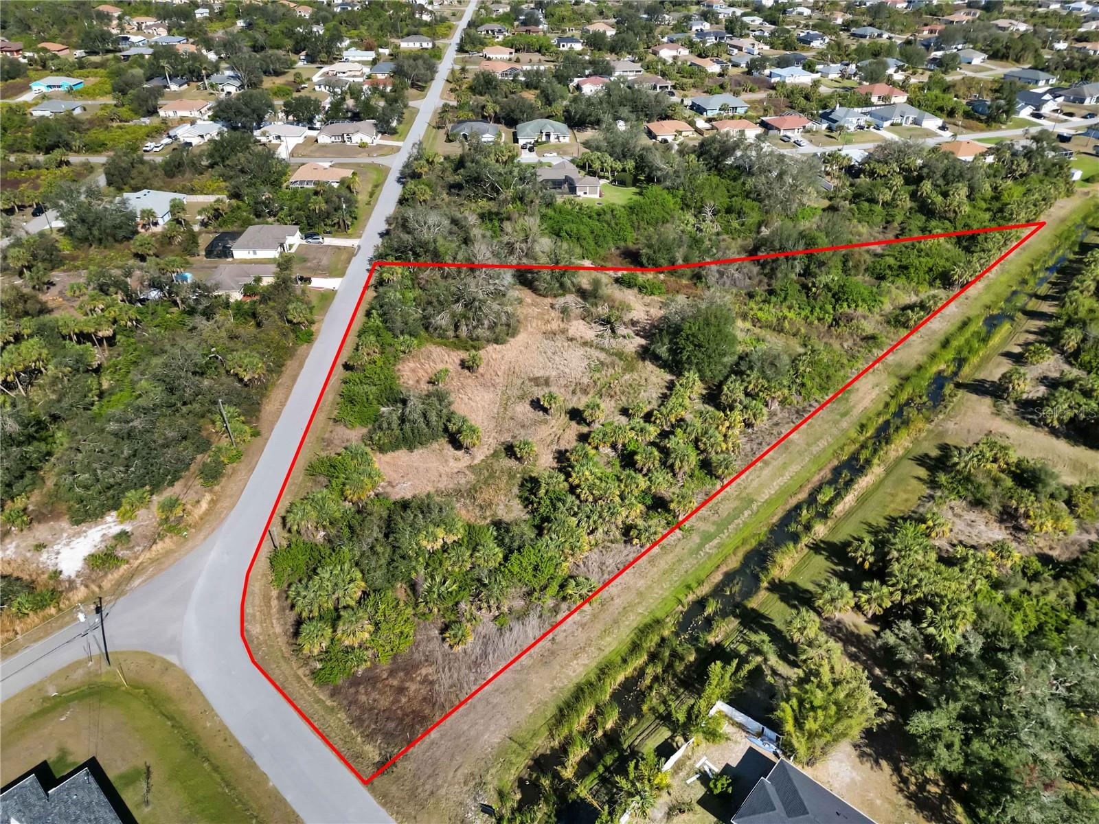 Embrace the rare opportunity to own 2.4 acres of prime land in the heart of North Port, offering the perfect blend of privacy and convenience. This impressive corner lot, partially cleared and backing onto a lush greenbelt, provides a natural buffer from neighbors, enhancing the sense of tranquility.
With city water available and electricity nearby, this property is ready for your vision. Zoned for flexibility and allowing subdivision, the possibilities for development or investment are endless. Located in an X flood zone, you can enjoy peace of mind knowing no flood insurance is required.
Ideally situated near shopping, restaurants, and schools, this property combines the seclusion of nature with the convenience of urban amenities. Whether you're dreaming of a private estate or a thoughtful investment, this exceptional parcel of land offers unmatched potential.
Discover the ultimate in lifestyle and opportunity—explore this remarkable North Port property today!