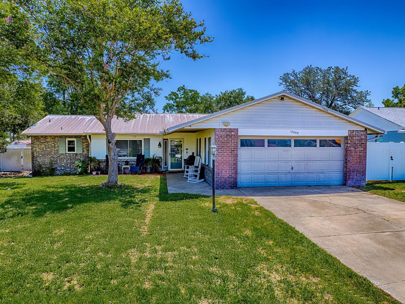 Welcome to 10849 SE 73rd Court in Belleview, Florida—an excellent opportunity to own a spacious home with strong potential in a quiet, established neighborhood. This 3-bedroom, 2-bathroom concrete block home offers over 1,700 square feet of living space and features a split-bedroom floor plan that provides both comfort and functionality.
The interior provides an open layout with a versatile flex space that’s perfect for a dedicated office, playroom, or bonus area. The garage has been partially converted to a fourth bedroom, while still preserving a separate storage area. The kitchen overlooks the dining and living areas, creating an easy, connected flow for everyday living. The primary suite includes a spacious closet and walk-in shower. Additional features include an inside laundry room, a metal roof installed in 2010, a heat-pump HVAC system, a newer water heater, and a security system for added peace of mind.
While the home has been well-maintained, some kitchen updates are already underway—making it ideal for a first-time buyer ready to build equity or an investor seeking a high-potential rental property. Sitting on just over a quarter-acre, the lot offers mature landscaping and ample outdoor space to personalize adding a garden, storage shed or even a chicken coupe!
Located in the desirable Green Meadows community that has NO HOA, you’ll enjoy convenient access to shopping, dining, and local schools, including Belleview High. Whether you're looking for your next home project or an investment opportunity, this property is full of promise.
Bring your vision and make it your own—schedule your private showing today!