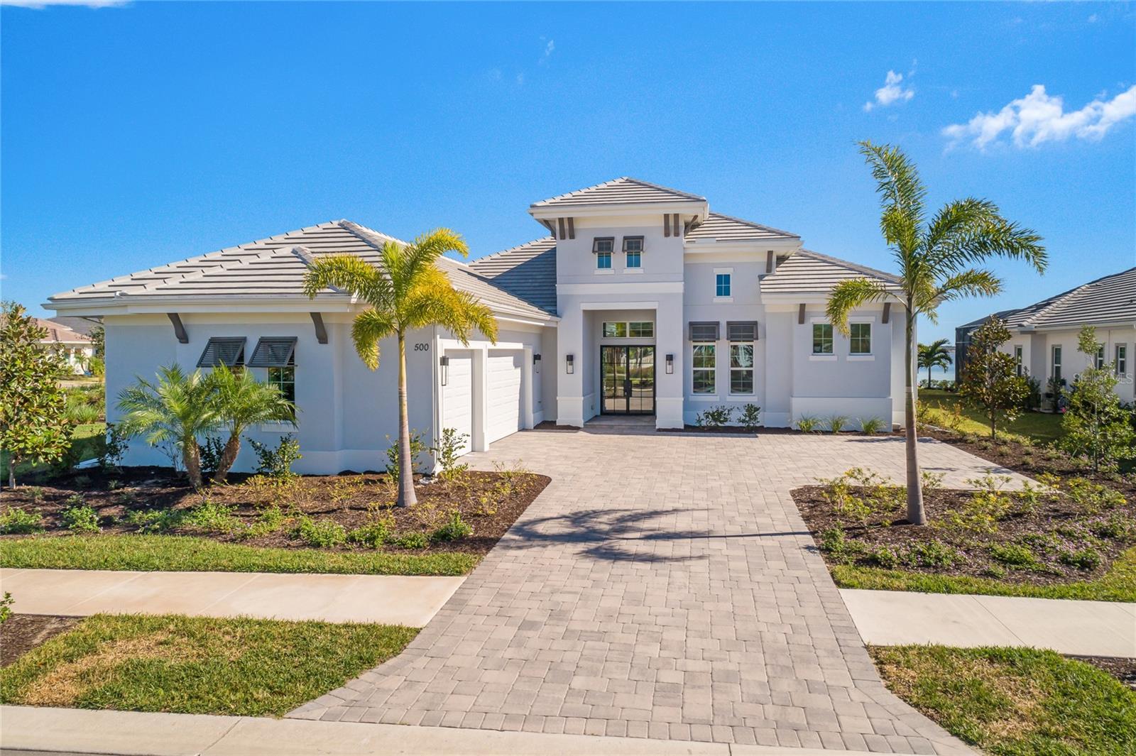 At WildBlue in Lakewood Ranch you’ll find yourself in the newest and most desired community in Sarasota County. Rated the top master planned community in the United States, this luxury home has it all to begin TURNKEY!!! Introducing this exceptional lakefront property in the coveted city of Lakewood Ranch, boasting a wealth of community amenities including 6 tennis courts, 8 pickleball courts, a playground, wetland overlook and boardwalk, dog park, event lawn basketball court, dock/kayak launch, and picnic areas with grilling stations and much more. This stunning home offers unparalleled outdoor experiences, with a pool, spa, outdoor kitchen, and fireplace all overlooking the serene lake views from the expansive patio and screened lanai. NEWLY CONSTRUCTED futures exclusive interior design elements, modern/contemporary style furnishing, luxury kitchen features, elegant bathroom features and more. OPEN concept living/dining, ceramic tile flooring, stainless steel appliances, quartz counter tops, pantry, walking closets, his and hers vanities, a modern self-standing bathtub. Gorgeous outdoor living invites you to enjoy unforgettable views, prepare the ideal meal in well appointed outdoor kitchen, to enjoy beautiful sunrises and immerse yourself in salt water infinity pool or spa. Tankless water heater, three-car garage, pre-wired automation system, impact resistant windows/doors, laundry in the residence. The kitchen features top-of-the-line stainless steel appliances, JennAir stove top, and winter maple cabinets, complemented by a wine cooler and outdoor grill by ASPIRE by HESTAN. Fantastic location with close proximity to restaurants, shops, golf, pickleball, and I-75 you’ll find this to be your dream home. Nearby to Siesta Key Beach, Ana Maria Island, and Longboat Key further elevate this property, making it a true treasure for discerning buyers seeking the ultimate Florida lifestyle.
