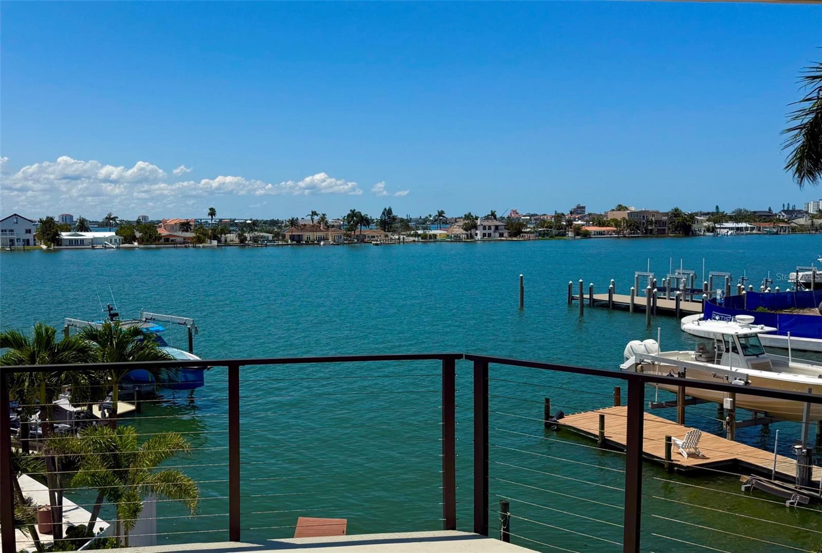 This exquisite custom waterfront residence features four bedrooms and three and a half bathrooms, complemented by a two-plus car garage. It offers approximately 2,900 square feet of air-conditioned interior space, along with an additional 1,000 square feet of outdoor deck space featuring Pli-Dek flooring. The home is move-in ready and underwent a complete renovation down to the studs full renovation in 2023/24. All electrical and plumbing systems have been newly installed, and the HVAC system has been upgraded. An abundance of windows, including motorized shades, provides a water view from every room, as well as an unobstructed view of the classic Don Cesar. The residence is equipped with a tankless hot water heater that includes recirculating lines, ensuring immediate access to hot water. Wind mitigation measures have been implemented, including a Hardie board exterior, tile roof, Pella hurricane-rated sliding doors and windows, stud strapping and shear walls. The first floor is lined with cement backer board on all walls. Additionally, a 22KW Generac generator is connected to a 500-gallon underground propane tank. The wood-burning fireplace has been renovated and features a new chimney cap and fireplace doors. The luxurious owner’s suite offers a spa-like bathroom with water closet and over-sized soaking tub, separate his and her walk-in closets and 10-foot glass doors overlooking Boca Ciega Bay. The home includes a three-stop elevator and an open floor plan that is ideal for entertaining. All new exterior highlights include a custom heated and cooled pool with champagne spa and sun-shelf, a travertine deck and covered lanai, lush tropical landscaping, an oversized driveway, sprinkler system, video surveillance, privacy fence, and a raised seawall. The property is situated on an exceptional lot in the upscale Bahia Shores on St. Pete Beach, providing easy access (a 10-minute walk) to a nationally top-ranked sugary white sand beach, epitomizing luxury resort-style living in Florida. This property offers affordable flood insurance. This residence experienced no flood and no hurricane damage in any of its living areas (inspected and confirmed by the city of St. Pete Beach). Furnishings are negotiable. The buyer to confirm square footage