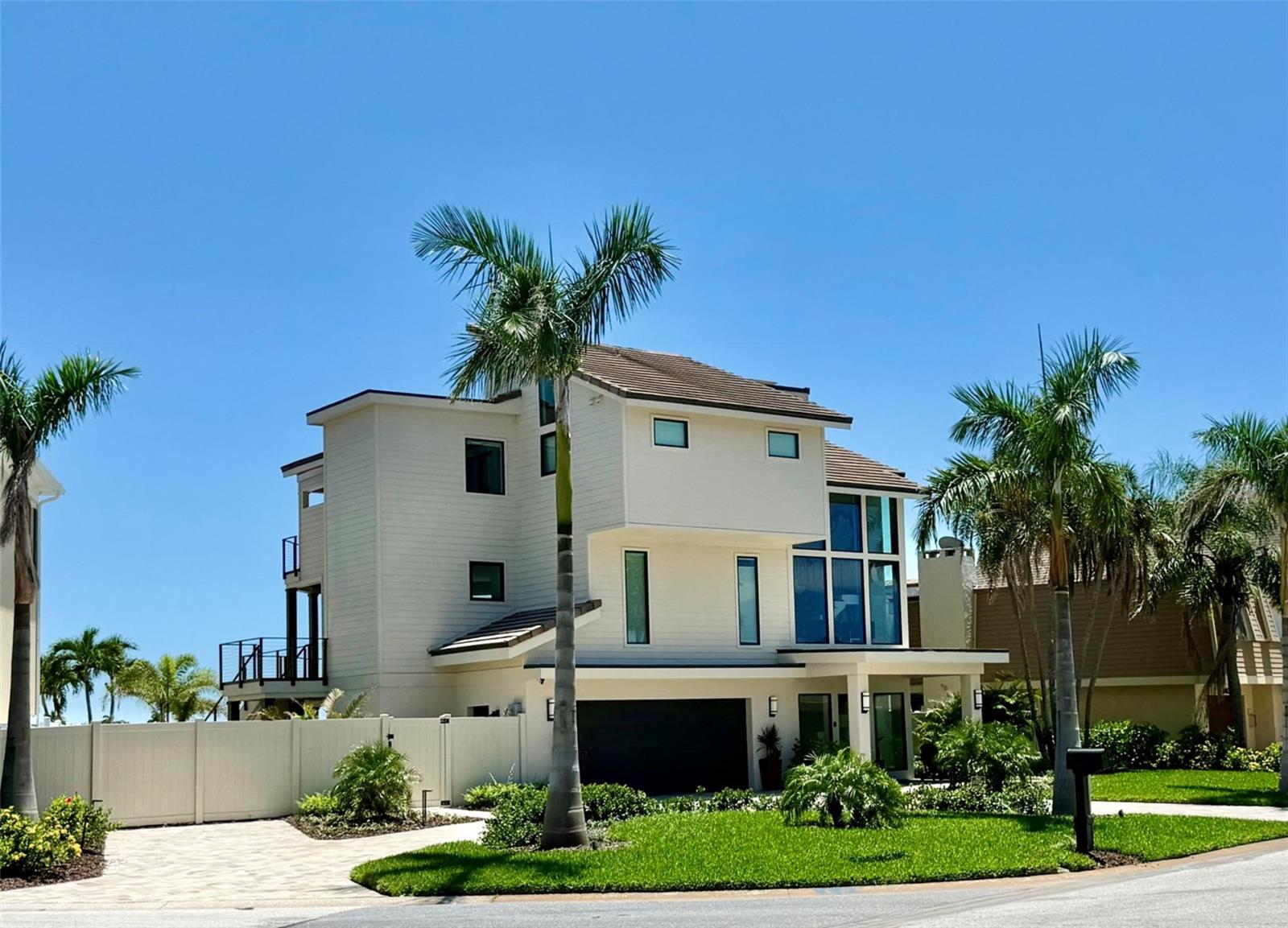 This exquisite custom waterfront residence features four bedrooms and three and a half bathrooms, complemented by a two-plus car garage. It offers approximately 2,900 square feet of air-conditioned interior space, along with an additional 1,000 square feet of outdoor deck space featuring Pli-Dek flooring. The home is move-in ready and underwent a complete renovation down to the studs full renovation in 2023/24. All electrical and plumbing systems have been newly installed, and the HVAC system has been upgraded. An abundance of windows, including motorized shades, provides a water view from every room, as well as an unobstructed view of the classic Don Cesar. The residence is equipped with a tankless hot water heater that includes recirculating lines, ensuring immediate access to hot water. Wind mitigation measures have been implemented, including a Hardie board exterior, tile roof, Pella hurricane-rated sliding doors and windows, stud strapping and shear walls. The first floor is lined with cement backer board on all walls. Additionally, a 22KW Generac generator is connected to a 500-gallon underground propane tank. The wood-burning fireplace has been renovated and features a new chimney cap and fireplace doors. The luxurious owner’s suite offers a spa-like bathroom with water closet and over-sized soaking tub, separate his and her walk-in closets and 10-foot glass doors overlooking Boca Ciega Bay. The home includes a three-stop elevator and an open floor plan that is ideal for entertaining. All new exterior highlights include a custom heated and cooled pool with champagne spa and sun-shelf, a travertine deck and covered lanai, lush tropical landscaping, an oversized driveway, sprinkler system, video surveillance, privacy fence, and a raised seawall. The property is situated on an exceptional lot in the upscale Bahia Shores on St. Pete Beach, providing easy access (a 10-minute walk) to a nationally top-ranked sugary white sand beach, epitomizing luxury resort-style living in Florida. This property offers affordable flood insurance. This residence experienced no flood and no hurricane damage in any of its living areas (inspected and confirmed by the city of St. Pete Beach). Furnishings are negotiable. The buyer to confirm square footage