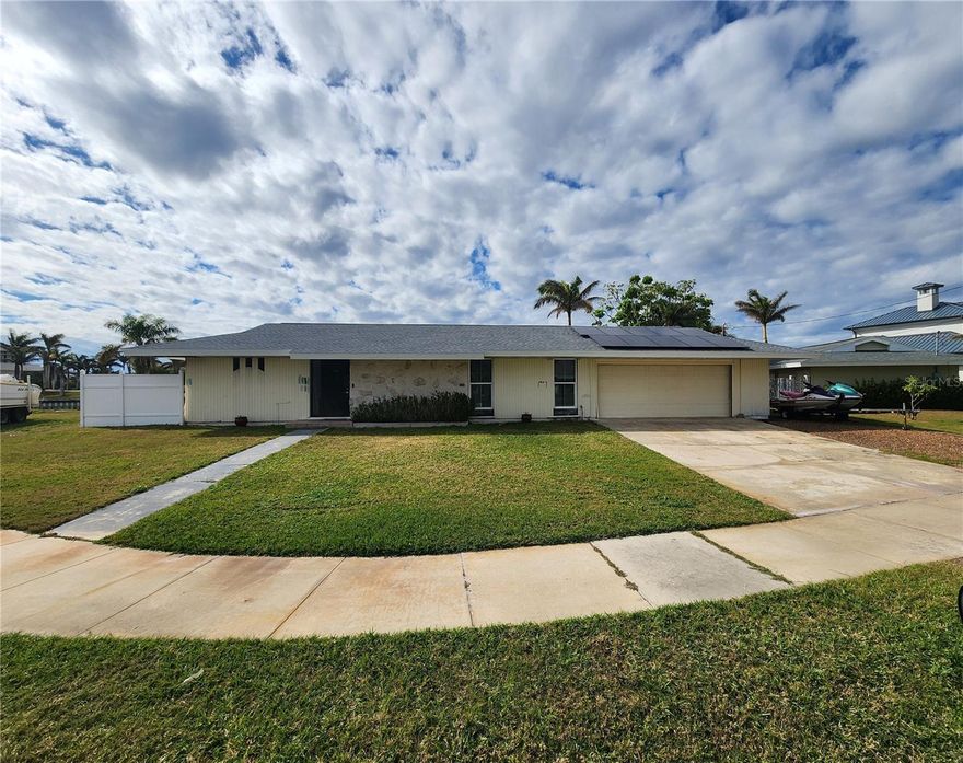 ACCEPTING ALL REASONABLE OFFERS- LISTED BELOW APPRAISAL VALUE ---- BOATER'S PARADISE – SAILBOAT ACCESS! HOME HAS NEVER FLOODED. This incredible waterfront property is a dream come true for boating and fishing enthusiasts! Situated on a deep, sailboat-access saltwater canal with a 113-foot concrete seawall, you'll enjoy direct access to Charlotte Harbor and the Gulf of Mexico with no fixed bridges. Whether you're an avid sailor or simply enjoy waterfront living, this property offers a lifestyle like no other. While this home needs some additional Love, The homeowners have already completed substantial updates, including a stunning kitchen makeover featuring a massive 11' x 4' quartz island, white shaker cabinets, a stylish backsplash, pendant lighting, and a wet bar with a 33-bottle dual-zone wine cooler—perfect for entertaining. This 4-bedroom split-floorplan home offers privacy and convenience. The spacious primary suite includes direct lanai access and serene water views, while the master bathroom remodel is underway, ready for your finishing touches. Updates include new flooring, shower tiles, vanity, and lighting. The guest wing features three generously sized bedrooms and 1.5 bathrooms, ideal for family or visitors, with easy access to the pool. The guest bathrooms also offer a great opportunity for updating to match your personal style. Major updates provide peace of mind: New Roof (2023), A/C (2020), Electrical Panel (2020), Solar Panels (2023,) Insulation Sprayed 2023, Step outside to the pool and lanai, where you can soak in the water views and enjoy Florida living at its finest. Prime Location, You are Minutes from Port Charlotte Beach Park, Close to the brand-new Sunseeker Resort and Punta Gorda Airport, Near historic downtown Punta Gorda with its vibrant shopping and dining scene, A short drive to the stunning Gulf beaches of Southwest Florida. This home combines waterfront serenity with easy access to all the best Southwest Florida has to offer. Don't miss this rare opportunity—schedule your showing today!