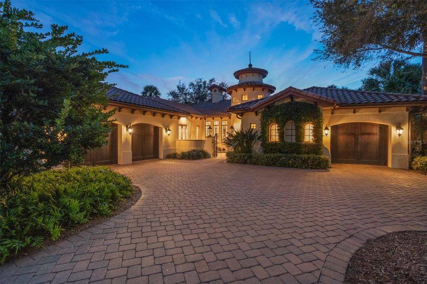 This beautiful home site is positioned within the Gardens of Isleworth –an intimate enclave of custom homes surrounded by lush gardens, water features, bridges, and walking paths. Built by Wyatt Anderson Construction, the single-story home spans more than 4,200 square feet and has been meticulously maintained. Exquisite finishes adorn the interior, from the marble floors with wood inlays, exposed wood ceiling beams and superb light fixtures throughout. The gourmet kitchen showcases custom Busby cabinetry and an oversized island which blend perfectly with the professional appliances, Italian tile backsplash and a gorgeous hood wrapped in hand-hammered French copper. The estate boasts three large ensuite bedrooms, including the primary suite – a fabulous retreat within the home featuring an elongated entry corridor, morning bar, private sitting area, custom closet and a spacious bath with dual sinks, and soaking tub. Situated just down the grand hallway is an expansive office suite with custom built-in cabinetry. The home also boasts an additional bonus room for crafting or extra office space. The open family room is a great space for entertaining family and friends, with corner sliding pocket doors opening to a picturesque indoor/outdoor oasis, garden and water views providing the backdrop for this alluring estate.