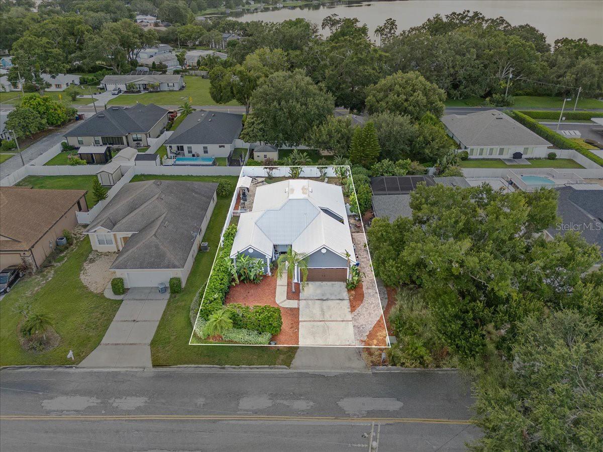 Welcome to this custom-built updated 3 bedroom, 2 bath pool home offering the perfect blend of comfort, convenience, and Florida living—all with no HOA and the peace of mind of a new metal roof installed in 2021 and a new A/C in 2022. Ideally situated just a short five-minute walk from Publix, Bealls, medical offices, dining options, and a postal store, you’ll love the accessibility of this prime spot.
Inside, you'll find a spacious and functional layout with an open great room, formal dining area, split bedroom plan, and an interior laundry room. The great room features a wall-mounted TV with surround sound, offers direct access to the lanai, and opens seamlessly to the kitchen—creating the perfect hub for everyday living and entertaining. The heart of the home is the custom-remodeled kitchen, featuring high-end cabinetry, granite countertops, a copper farm sink, tiled backsplash, stainless steel appliances including a wine chiller, and an island with a breakfast bar. Whether you're gathering for casual meals or hosting in the formal dining room with views of the peaceful atrium, the space is warm, welcoming, and highly functional.
The private primary suite offers two walk-in closets, direct access to the lanai, and its own mini-split A/C system for personalized comfort. The en-suite bath features dual sinks, a jetted soaking tub, walk-in shower, private water closet, and linen storage. Two additional bedrooms are located on the opposite side of the home, one also with a mini-split system, and both near a beautifully updated guest bath with a floor-to-ceiling tiled walk-in shower and granite vanity.
Practical features include an interior laundry room with washer, dryer, utility sink, and storage cabinetry, along with a two-car garage for added convenience.
Step outside to your private outdoor retreat, where a spacious covered lanai leads to a heated pool with sun shelf (installed in 2015)—the perfect place to relax and unwind. The backyard also features a hot tub, covered grilling area, expansive paver pool deck, and a fully fenced yard for privacy and year-round enjoyment. Whether you're hosting weekend BBQs, pool parties, or quiet evenings under the stars, this outdoor space was made for entertaining.
Additional highlights include ceiling fans, window treatments and tile flooring throughout the interior, 3 wall-mounted TVs, mature tropical landscaping and an irrigation system with timer. Located within the city limits of Winter Haven, this home is eligible for use as a short-term rental on platforms like Airbnb or VRBO. Perfectly located between Tampa and Orlando with easy access to both coasts and close to area attractions, this stunning home offers exceptional value in a prime Central Florida location.