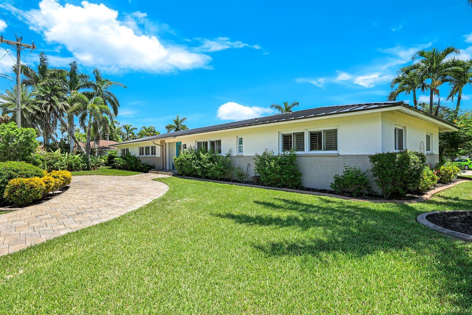 Experience the ultimate Florida waterfront lifestyle with this stunning Gulf-access pool home, located just minutes from open water with no bridges in the highly sought after YACHT CLUB of Cape Coral FL. Perfect for entertaining, large family gatherings or simply a personal retreat, the oversized corner lot features an electric heated saltwater pool, spacious screened lanai, outdoor kitchen with built-in grill, and a pet-friendly backyard with decorative curbing. Boaters will love the marine-grade dock with a 10,000 lb boat lift, ready for endless days on the water. Inside, the home offers 4 bedrooms, 4 bathrooms, a large Florida room with plantation shutters, and a combination of hardwood and laminate flooring throughout. The coastal decor and casual feel is relaxing after a a day on the water or on white sandy beaches. The kitchen is beautifully appointed with granite countertops, white shaker cabinets, stainless steel appliances, a double oven, and a charming bread basket nook, all flowing into formal and casual dining spaces. The primary suite boasts hardwood floors, a hidden closet behind the mirror, an ensuite bathroom with dual sinks, extra cabinetry, a jacuzzi tub, frameless glass shower, and direct access to the pool and lanai. Additional features include a 2024 metal roof, impact windows and doors, two A/C units, a large laundry room with storage and counter space, and a Jack & Jill bathroom with leather-textured countertops. The pool cage screens were recently repaired after Hurricane Ian, and the pool heater and pump are only three years old, ensuring peace of mind and top-notch amenities for the next lucky owner. The home also features permanent Gemstone LED track lighting, fully customizable through a smartphone app with millions of color options, perfect for security, holidays, and everyday curb appeal. Ideally located just minutes from downtown Cape Coral, the highly anticipated Bimini Basin, and the famous Cape Coral Yacht Club featuring restaurants, a resort-style pool, pier, playground, boardwalk, and community center, PLUS you’ll enjoy quick access to waterfront dining, boutique shopping, entertainment, white sandy beaches, all the vibrant lifestyle Southwest Florida has to offer - not to mention front row seats to the annual fireworks celebrations! Schedule your appointment today and secure your slice of paradise!