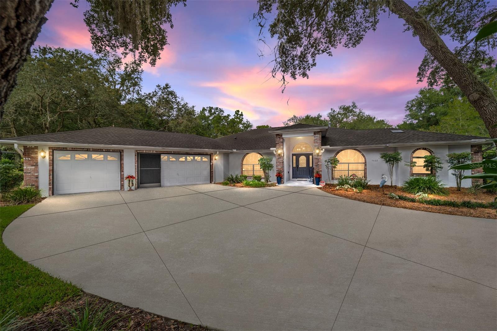 Tucked away on nearly an acre in the prestigious Fairview Estates of Citrus Hills, this beautifully updated 3-bedroom, 2.5-bath estate with a versatile flex room and 3-car garage offers a seamless blend of comfort, sophistication, and Florida lifestyle. Spanning 2,653 square feet, the home welcomes you with soaring ceilings, abundant natural light, and a warm, open layout perfect for both quiet living and vibrant entertaining. A gracious double-door entry opens to a flexible space ideal for a home office, formal sitting area, or creative studio. Just beyond, the spacious great room features a cozy gas fireplace, custom TV mount, and multiple sliding glass doors that invite the outdoors in. Thoughtful touches like luxury vinyl plank flooring, crown molding, ceiling fans, and French doors elevate every corner of the interior. The heart of the home is the stunning, gourmet kitchen—anchored by a gleaming quartz island and equipped with stainless steel KitchenAid appliances, soft-close painted cabinetry, under-cabinet lighting, and a skylight that bathes the space in natural sunshine. A walk-in pantry and a wraparound dining nook with a chandelier and picture windows provide both function and flair, with direct access to the lanai for effortless indoor-outdoor dining. The primary suite is a true retreat, offering double-door entry, high ceilings, four windows—including two with custom stained glass—sliding door access to the lanai, and dual walk-in closets with built-in storage. The spa-inspired en suite bath features his-and-her sinks, a vanity area, walk-in tile shower with built-in bench, luxurious jetted soaking tub, a skylight, and private water closet with additional cabinetry. Split from the owner's wing, the two guest bedrooms each offer LVP flooring, ceiling fans, generous closets, and unique architectural details like window seating and direct lanai access. The full guest bath includes a tiled tub/shower combination, single sink vanity, and convenient entry from the pool area. A half bath and well-equipped laundry room with upper and lower cabinetry, utility sink, and window with a pocket door add to the home’s efficiency. Step outside to a fully pavered, screened lanai with ceiling fan and a sparkling electric-heated, saltwater pool nestled beneath a birdcage enclosure. The meticulously landscaped backyard is a tropical escape, complete with banana, tangerine, pineapple, and mulberry trees, motion-activated lighting, and a full-size shed with garage-style and walk-in entry. The three-car garage is finished with a ceiling fan, screened doors, utility sink, side entry to the yard, and windows for natural light. Additional upgrades include tinted windows throughout, a security system with a Ring camera, water softener, updated bathroom fans and heaters. The freshly painted front door and entryway are framed by blooming crepe myrtles that welcome you home. Perfectly positioned in one of Citrus County’s most desirable communities, this home offers the peace and space of estate living with optional access to world-class Citrus Hills amenities, golf, and wellness facilities.
