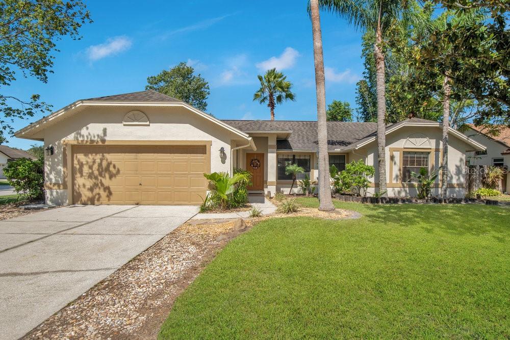 Charming Oasis Retreat with Elegant Features and Serene Outdoor Living.
Step into this beautifully maintained 3-bedroom, 2-bath home designed for comfort, functionality, and relaxed indoor-outdoor living. Featuring a desirable split floor plan, the home boasts a spacious great room with a cozy fireplace and French doors that lead to a trellised patio adorned with flowering vines and plumbed for a refreshing misting system-perfect for enjoying morning coffee or entertaining guests year-round.
The spacious kitchen is a cook’s delight with Corian countertops, a center island, full appliance package, and ample cabinetry, ideal for both everyday living and hosting. Two of the bedrooms showcase elegant crown molding and rich wood flooring, while the primary suite includes its own access to the large tiled sunroom and serene backyard.
Outside, escape to your private landscaped oasis complete with a tranquil pond, An outdoor shower offering the added convenience for garden enthusiasts and outdoor rinse-offs, area for grill and an arbored seating area.
Additional highlights include an air conditioner less than 2 years old, roof is 9 years old. T and tasteful finishes throughout that reflect pride of ownership. This home blends timeless style with peaceful outdoor amenities—perfect for those who love nature, entertaining, or simply relaxing at home.