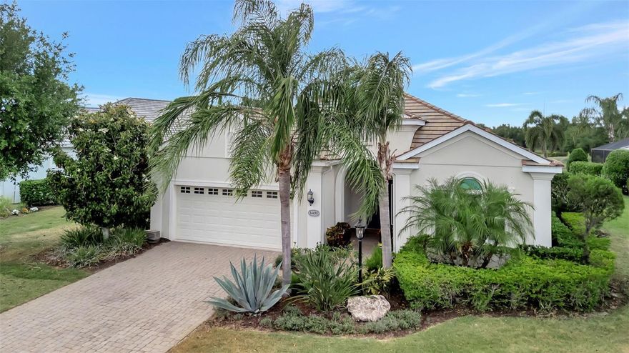 Experience maintenance-free living in the guard-gated community of Country Club East in Lakewood Ranch. This open-concept 3-bedroom, 2-bath, 2-car garage single-family home offers both comfort and convenience, with lawn care and irrigation included. Enjoy peaceful lake views from the spacious screened lanai—perfect for relaxing evenings and sunset views. Inside, you’ll find 10-foot ceilings, plantation shutters, granite countertops in the kitchen, stainless steel appliances, a breakfast bar, and both a casual dining nook and formal dining area ideal for entertaining. One of the guest bedrooms features bamboo flooring and double entry doors, making it a perfect home office, den, or study. The primary suite offers dual vanities and a large walk-in shower, while new hurricane-rated windows and doors provide added value and peace of mind. A dedicated laundry room adds everyday convenience, and the 2-car garage includes a mop sink for added functionality. Residents enjoy access to three community pools, a fitness center, clubhouse, recreation center, billiards, sand volleyball, and a resort-style pool, with one pool just a short walk away. Optional memberships are available for golf and social activities. Located in a top-rated school district and just minutes from premier entertainment, this home offers convenient access to downtown Sarasota, Lido Beach, and Siesta Key—making it easy to enjoy the very best of Florida’s Gulf Coast lifestyle.