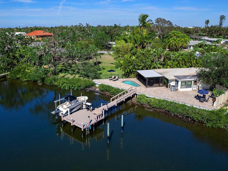 WATERFRONT DUPLEX. Tucked away on a small private street is a charming duplex on Philippi Creek. Gorgeous views from the backyard overlooking 119 feet of waterfront. Boaters will delight in the Azek dock and 10,000-pound boat lift, complete with fish cleaning station, water and electric. There is a new seawall, as well as ample room for an additional lift. It is less than one mile to the Intercoastal waterway and Sarasota Bay. The pool area has a newly landscaped private courtyard, a large paver deck, with plenty of entertaining space. The home is being used as a duplex, with the owners living on the waterfront and having income from the other side. It could, and has in the past, lived as a single-family residence. Each side is two bedrooms and one bath, with separate electric and water meters. The property is fenced, has a standing seam metal roof and is being sold turnkey furnished. The lanai, with its new ClearView screen, offers amazing sunsets from the privacy of your new home. Central to restaurants, schools and shopping, while just a bike ride to Siesta Key Beach.