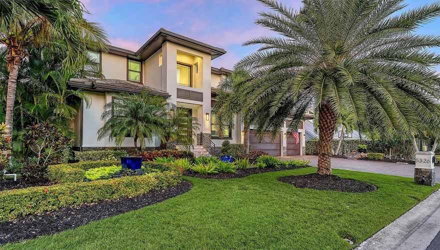 An extraordinary statement of modern coastal elegance, this custom waterfront residence built in 2018 is a masterclass in refined living, where architectural detail, craftsmanship, and setting converge in the coveted enclave of Siesta Cove. Framed by sweeping water views and constructed with hurricane-rated windows and doors, the residence offers both elevated design and enduring peace of mind. Spanning five bedrooms and six full bathrooms, the home is thoughtfully curated for effortless luxury. The primary en-suite retreat on the main level provides a private sanctuary, while light-filled interiors and tranquil water vistas create a seamless connection to the outdoors from nearly every room. The great room commands attention with intricate ceiling artistry, custom built-in shelving, and a sleek electric fireplace—an inviting yet dramatic centerpiece for both intimate evenings and grand entertaining. A temperature-controlled walk-in wine cellar and elegant wet bar elevate the experience further. At the heart of the home, the kitchen is a vision of light and sophistication, featuring new designer Cambria countertops (Wolf & Subzero appliances) including double ovens, built-in refrigerated drawer and a built-in freezer drawer, a generous walk-in pantry, and a welcoming eat-in layout complemented by an adjacent breakfast bar. Plantation shutters and discreet electric blinds throughout the home enhance the ambiance with effortless control of light and privacy. A richly appointed den or office behind French doors offers quiet refinement, while a sweeping staircase ascends to an upper level designed for both comfort and indulgence. Here, a spacious bonus room opens to a private screened balcony, ideal for sunrise reflections or sunset cocktails. Four additional bedrooms include three luxurious en-suite accommodations and a fourth with a dedicated full bath just beyond. One suite is distinguished by its own wet bar with refrigeration for morning coffee or evening refreshment, along with custom built-in closet drawers—an unexpected touch of indulgence. The outdoor living experience is nothing short of resort-caliber. A sparkling pool and spa, enhanced by a new electric pool heater, are complemented by an outdoor shower, built-in grill, and beverage cooler—creating a private oasis for entertaining under the stars. Boaters will appreciate the 39-foot private dock with water, electric, and lift, just moments (only 3 properties away) from the Intracoastal Waterway. Additional features include an elevator servicing all levels from the oversized three-car garage, abundant storage, a fully fenced yard, and lush, mature landscaping that envelops the property in privacy and beauty. Perfectly positioned near world-class beaches, upscale shopping, and fine dining, this exceptional Siesta Cove residence is more than a home—it is a lifestyle defined by grace, comfort, and uncompromising waterfront luxury.