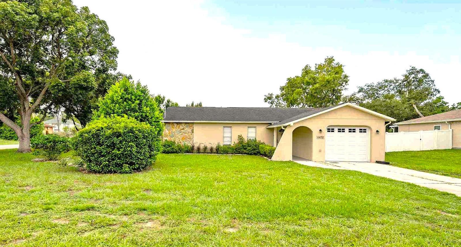 Beautiful Home with large corner yard! …..plus a Separate Garage! Enter though the covered front walk-way. The spacious open floor plan also allows for separation. Comfortable front room easily fits a huge sectional couch. Many updates ~~ Kitchen with stainless appliances, stone counters, pantry cabinets plus a closet pantry. The Breakfast Bar ~ ‘heart of the kitchen’ is perfect for family time and entertaining! The dining room area features a decorative shiplap wall and the family room is adjacent. The three bedrooms all have ceiling fans and ample closet space. Bedroom 2 is currently used as an office ~ and now has beautiful new vinyl plank flooring just installed! ~ Handy Linen Closet ~ Both baths contain updated vanities with stone counters. The covered, screened patio encourages morning coffee. The SEPARATE garage with Unlimited Uses is accessed from the side road with a private driveway (and this garage is insurable). Roof is only 9 years old. 3 ton AC is 2 years old & includes a 10 year warranty. Water heater is 4 years old. Trash collection is included in your property taxes. No HOA!! Washer & Dryer remain for the new owners...along with a Ring Doorbell!