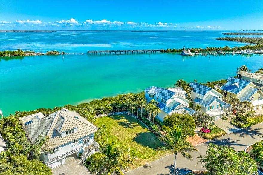 Enjoy stunning and expansive harbor views from this ideal bay-front lot, situated within an exclusive waterfront community. Welcome to Grande Quay, where you’ll be part of a small and private 13 home development with excellent amenities, which include: beautiful, lush landscaping, security gates, and a dedicated boat trailer lot. For avid boaters, the community has a private and newly constructed boat dock. An oversized and deeded 30-foot boat slip with a 16,000 lift is included with the sale of the property. This makes it easy to stroll down the street to your private boat slip and be on the Gulf of Mexico or inter-coastal waterway in no time. The view from the property is breath-taking! Right behind the property watch the dolphins and tropical birds as they often play in and around this slice of paradise. Additionally, Gasparilla Island is renowned for its world-class fishing, making it an excellent choice for anglers. You will love the quaint village of Boca Grande, providing a charming and serene atmosphere, with local amenities and a small town feel. This build-ready parcel presents an incredible opportunity to own a piece of paradise. Fully designed house plans, detailing 3100SF air-conditioned living space, are available, stream-lining the build process and speeding up the time frame for you to begin enjoying your new home.