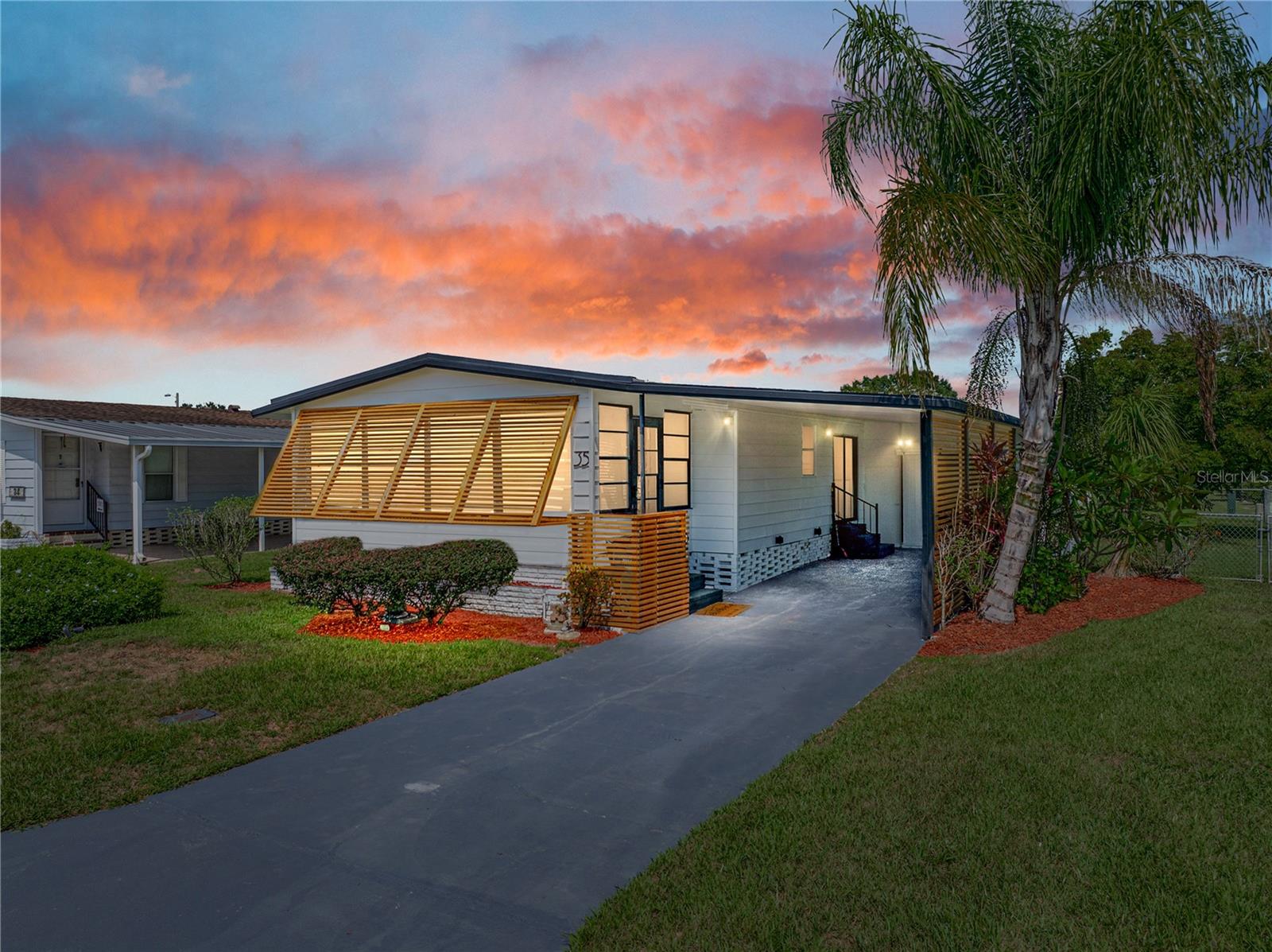 Step inside this beautifully fully renovated two-bedroom, two-bathroom manufactured home where modern style meets everyday comfort, located in the desirable 55+ Citrus Woods Estates community! From the moment you enter, you’ll notice the attention to detail, with luxury vinyl plank flooring running seamlessly throughout the living spaces, creating a warm and inviting atmosphere. The updated kitchen is the centerpiece of the home, featuring stainless-steel appliances, a monochromatic color scheme, and a spacious island with bar-style seating—perfect for casual meals or entertaining guests. The open layout ensures effortless flow between the kitchen, dining, and living areas, making the home feel bright and welcoming. Both bedrooms are generously sized and include walk-in closets, providing plenty of storage space. The primary bedroom is a relaxing retreat, complete with its own en suite bathroom, offering privacy and convenience. The second bedroom and bathroom are equally well-appointed, ideal for guests or a home office setup. Move-in ready and thoughtfully updated, this home offers the perfect blend of modern finishes and functional design. Whether you’re starting out, downsizing, or looking for a seasonal retreat, this property provides exceptional value and comfort.