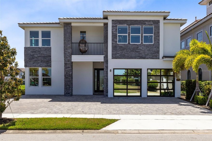 One or more photo(s) has been virtually staged. Tastefully upgraded vacation property in one of Reunion Resort’s most distinguished neighborhoods and within a short distance to the Jack Nicklaus Clubhouse and restaurant. This spacious property, originally designed as a 12-bedroom home, has been thoughtfully recrafted to now offer six generously sized bedrooms each with its bath along with countless décor and finish upgrades, turning a simple house into a comfortable and luxurious second home. Attention has been paid to detail in every area of the home, from the attractive contemporary mirrored glass garage doors that greet you as you drive up, to the wainscoting and millwork that guide you from the front door entry through to the open living room overlooking the private pool area with summer kitchen, to the amazing Scavolini italian kitchen with floor-to-ceiling high quality smooth white cabinets that masterfully disguise the Gaggenau appliances to the upstairs main suite with sparkling white freestanding soaker tub, double shower with spa system and sumptuous Scavolini main closet with dresser island. Recreation for all ages and interests has been accommodated with a large open entertainment loft, a cozy movie room and an incredible home gym. There is also space to add a games area either in the loft or in the air-conditioned garage, and the recreation areas can also be refurnished as bedrooms if potential maximum rental income is desired. The home offers an active membership to the Reunion Club to assure optional full access to all of Reunion’s amenities including three private golf courses, 11 swimming pools and an on-site water park, a lighted tennis and pickleball complex, gym, mini-golf, on-site shuttle service and a variety of on-site bars and restaurants. All this just six miles from the Walt Disney World Resort entrance, just waiting for your visit. Qualified buyers may receive a 1-year interest rate buydown for the first year paid for by the Seller's preferred lender when financing this home  (subject to credit approval and program availability) - call today for details.