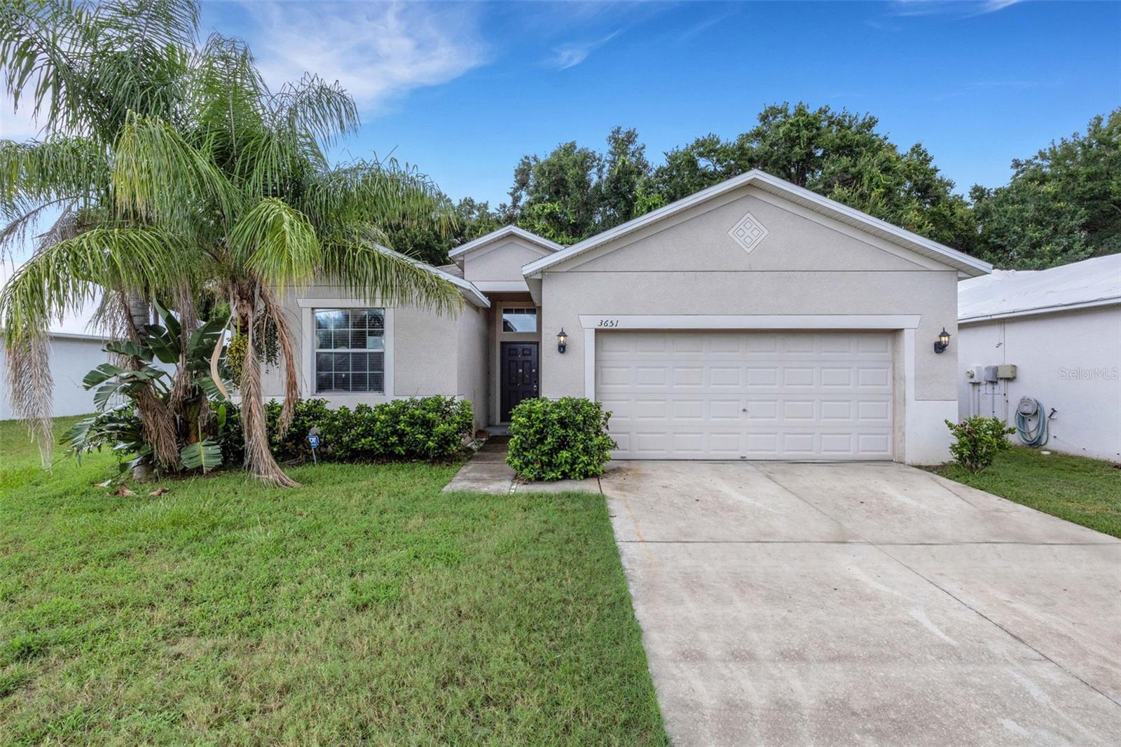 Welcome to Lakeland's Hampton Hills South. This 1 story block home offers an open concept floorplan with 1533 square feet, 3 bedrooms, 2 bathrooms and 2 car garage. Split bedroom floor plan greets you at the entrance with the secondary bedrooms sharing a full bath to your left. Continue down the hall to the spacious family and dining room area directly off the kitchen. Open and spacious. Kitchen includes closet pantry, ample cabinets and counter space- plenty of room to add a kitchen island. Sliding glass doors take you onto a covered patio with wooded views. The primary Suite is directly off the family room, separate from the secondary bedrooms. Includes walk in closet, dual sinks, soaking tub and step in shower. Easy access to interstate, restaurants and shopping. It's good to be home. This property may qualify for Seller Financing (Vendee). It's good to be home!