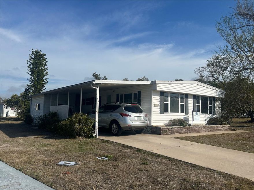 Welcome to comfortable, low-maintenance Florida living in this well-situated double-wide mobile home in the 55+ gated Holiday Park Special District. With a 2014 roof and 2018 above-ground gas system, this home is a great opportunity for affordable, relaxed living in a community built for fun and connection.

Holiday Park offers an active lifestyle with abundant amenities, including 14 shuffleboard courts, 6 horseshoe pits, 4 pickleball courts, 3 tennis courts, 3 bocce courts, 3 ping pong tables, 2 heated pools, a fitness center, billiard room, card rooms, library, ceramic building with kiln, dart room, and a laundry facility. With a monthly newspaper and tons of planned activities, there’s always something to enjoy and neighbors to meet.

Holiday Park provides both social variety and peace of mind, making it easy to stay active, make friends, and enjoy the Florida sunshine. And beyond Holiday Park, North Port itself offers a laid-back lifestyle with abundant outdoor recreation, freshwater lakes and canals, nature parks, and the famous Warm Mineral Springs nearby for year-round relaxation and wellness. Great opportunity to own a home in affordable Holiday Park, North Port FL. LOW maintenance/recreation fee included in the property tax bill annually at $2,340.00, NO HOA and NO CDD fees! Spacious double wide home sited on a pie shaped cul de sac lot. Home with 3 bedroom 2 full baths. Large living room with built in shelving and large cabinet storage space. Large eat in kitchen with kitchen island. Enjoy the Florida room off the kitchen. Large hall full bath with tub/shower and many cabinets. Exterior door to a full screened cage. Large Primary bedroom with full bath with beautiful tile and stone flooring shower. Many closets in bedroom. Extra long carport and storage shed for more storage. Many possibilities with this large home. Schedule your private showing today! Come check out this spacious home!

Just a short drive to Gulf beaches, shopping, dining, and major roadways, this home brings together convenience, community, and classic Florida living — don’t miss this special opportunity.