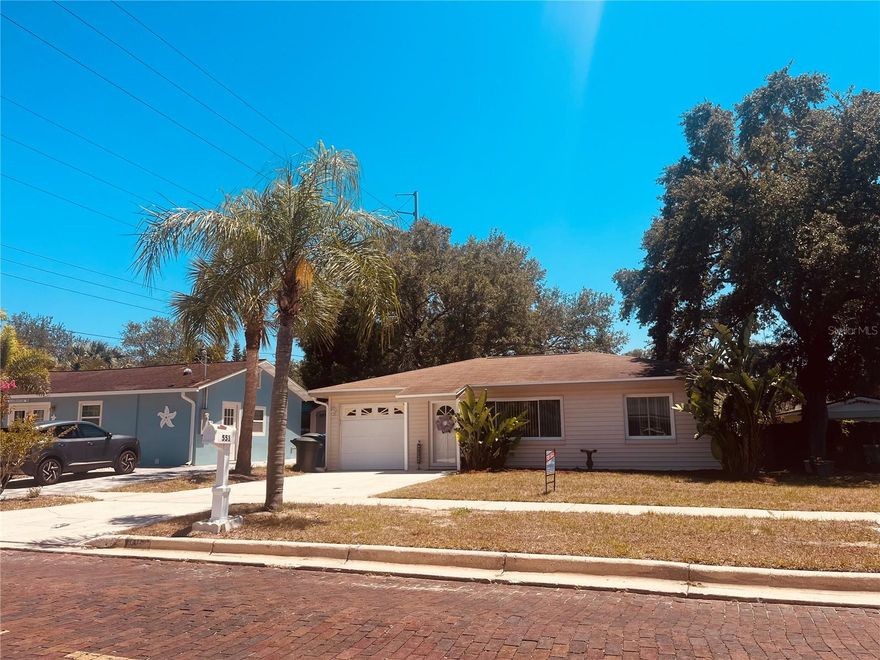 Situated in quiet, established Old Dunedin neighborhood near the Pinellas Trail & Edgewater Drive on the water, featuring mature landscaping. This 2 BDR/1BATH highly desired Dunedin Bungalow/Cottage has been renovated with modern amenities while maintaining its 1950s charm, and it is located in a high-ground area. X Flood Zone. Pride of Ownership in every detail. This Owner has lived in and loved this home for 31 years. 2023 hot water tank. Can be left furnished. 14 inches of insulation blown into attic. The carport has been converted into a single garage with a garage door opener, and also a double driveway!! There is a man door to the outside and also a door connecting to the home through the kitchen!Dishwasher is brand new! Five burner oven!! With a warming plate! Windows have been replaced with double pane windows. Wait until you see your beautiful fenced in backyard that comes with a shed, a freshly stained wooden deck and a freshly painted concrete pad! New Man door installed on garage to large/fenced back yard! Beautiful old rose bushes that the Owner wishes she could take with her! The MODERN kitchen has been beautifully remodeled with  built-to-ceiling from maple, painted white cabinets AND a GORGEOUS BLACK Waterfall Corian countertop! Stainless steel appliances. Soft closed drawers. Kitty corner cabinets. You have a Dining area in kitchen! No popcorn ceilings, all have been done beautifully, and everything is freshly painted! NEW washer and BIG dryer in separate laundry room an garage with a window for fresh air circulation! There are sliders from the kitchen onto your large deck. Both fans have remote control controls and the second bedroom has a Voisin fan with light! Cedar closets! Plenty of windows for letting in our beautiful natural light sunshine in Florida! Full Murphy bed and second bedroom. Built-in linen cupboard in second bedroom. It also comes with a dimmer and different luminescence settings.  Vinyl siding, so you never have to repaint! Waterproof vinyl planking throughout. Ceramic tile in both bedrooms! Front door has been replaced and also a new lock and handle and new exterior lighting outside your front door!  All doors throughout have lever door handles and rocker light switches!! All interior doors have been replaced! Cinderblock home AND NO FLOOD ZONE make this SOLID home even more desirable!! Half mile to Edgewater Drive overlooking the intracoastal Waters in Saint Joseph sound! Two blocks from the Pinellas Trail.