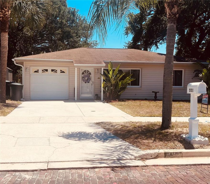 Situated in quiet, established Old Dunedin neighborhood near the Pinellas Trail & Edgewater Drive on the water, featuring mature landscaping. This 2 BDR/1BATH highly desired Dunedin Bungalow/Cottage has been renovated with modern amenities while maintaining its 1950s charm, and it is located in a high-ground area. X Flood Zone. Pride of Ownership in every detail. This Owner has lived in and loved this home for 31 years. 2023 hot water tank. Can be left furnished. 14 inches of insulation blown into attic. The carport has been converted into a single garage with a garage door opener, and also a double driveway!! There is a man door to the outside and also a door connecting to the home through the kitchen!Dishwasher is brand new! Five burner oven!! With a warming plate! Windows have been replaced with double pane windows. Wait until you see your beautiful fenced in backyard that comes with a shed, a freshly stained wooden deck and a freshly painted concrete pad! New Man door installed on garage to large/fenced back yard! Beautiful old rose bushes that the Owner wishes she could take with her! The MODERN kitchen has been beautifully remodeled with  built-to-ceiling from maple, painted white cabinets AND a GORGEOUS BLACK Waterfall Corian countertop! Stainless steel appliances. Soft closed drawers. Kitty corner cabinets. You have a Dining area in kitchen! No popcorn ceilings, all have been done beautifully, and everything is freshly painted! NEW washer and BIG dryer in separate laundry room an garage with a window for fresh air circulation! There are sliders from the kitchen onto your large deck. Both fans have remote control controls and the second bedroom has a Voisin fan with light! Cedar closets! Plenty of windows for letting in our beautiful natural light sunshine in Florida! Full Murphy bed and second bedroom. Built-in linen cupboard in second bedroom. It also comes with a dimmer and different luminescence settings.  Vinyl siding, so you never have to repaint! Waterproof vinyl planking throughout. Ceramic tile in both bedrooms! Front door has been replaced and also a new lock and handle and new exterior lighting outside your front door!  All doors throughout have lever door handles and rocker light switches!! All interior doors have been replaced! Cinderblock home AND NO FLOOD ZONE make this SOLID home even more desirable!! Half mile to Edgewater Drive overlooking the intracoastal Waters in Saint Joseph sound! Two blocks from the Pinellas Trail.