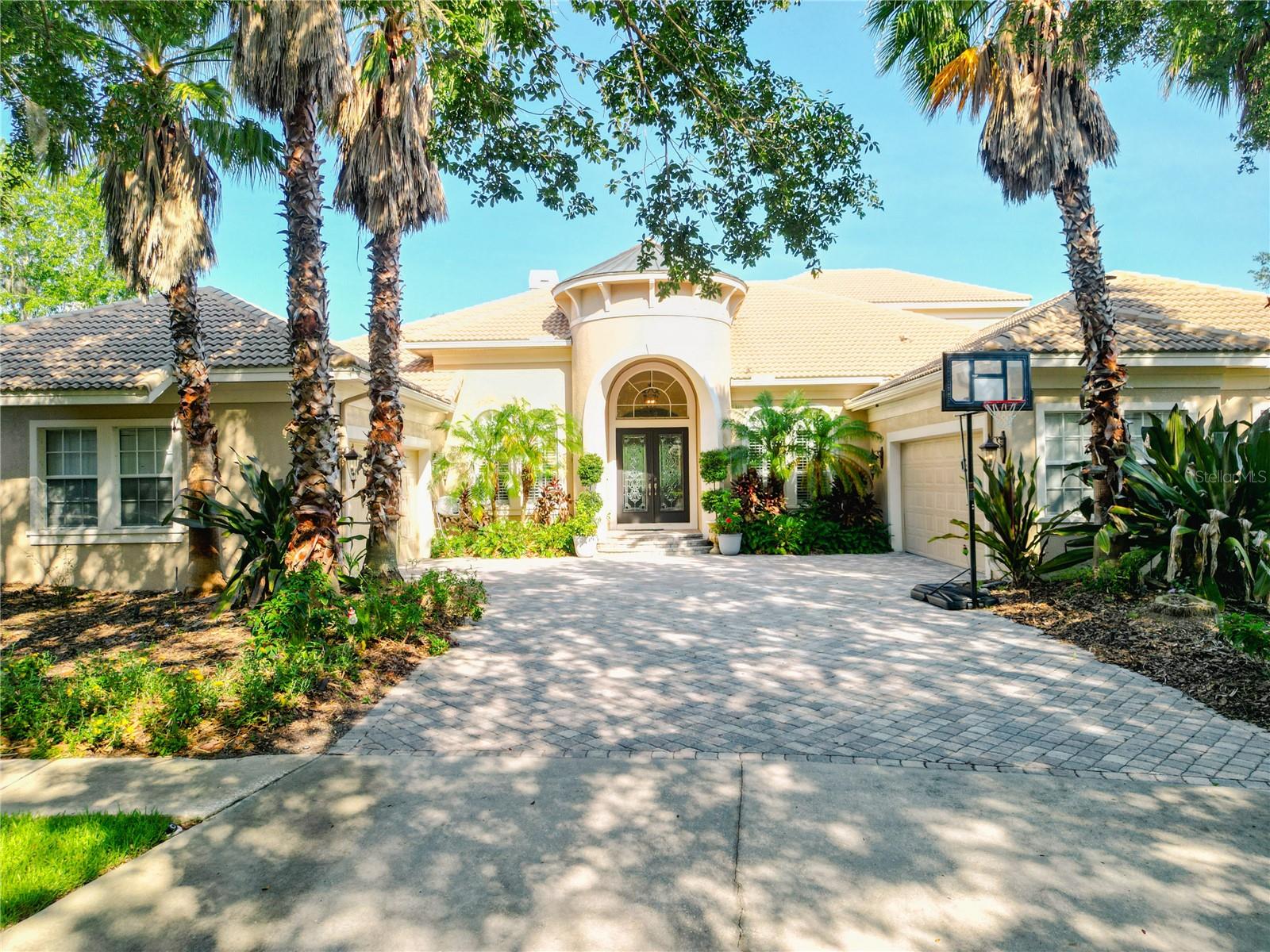 Experience unparalleled luxury in this extraordinary 5,000-square-foot custom-built residence by renowned builder Hannah Bartoletta, ideally situated on a private cul-de-sac lot in the exclusive gated enclave of Kestrelridge in FishHawk Ranch, with stunning conservation and water views creating a peaceful, picturesque backdrop; this architectural masterpiece is designed for both refined entertaining and relaxed living, featuring a resort-style outdoor oasis with a screened and covered lanai finished in travertine tile, heated pool and spa, gas fireplace, full outdoor kitchen, and seamless indoor-outdoor integration through expansive triple pocket sliding doors in the family room. while inside, the home exudes sophistication with soaring 12-to-14-foot ceilings, intricate tray and coffered detailing with ceiling beams, crown molding, decorative columns and arches, Spanish tile and diagonal inlays, granite countertops, and custom wood cabinetry throughout; the gourmet kitchen is a chef’s dream complete with a gas stove, range hood vented to the outside, double ovens, upgraded 65” upper cabinets with crown molding, a fully built-out pantry with custom shelving, and an adjacent wine room with built-in wood finishes; the expansive and light-filled living areas are further elevated by designer chandeliers in the formal dining, living, and family rooms, while the thoughtfully designed layout includes a luxurious first-floor primary suite, private guest suite with en-suite bath, dedicated home office with built-in desk and cabinetry, state-of-the-art home theater, powder bath, pool bath, and a well-equipped laundry room with a hand-washing sink, and upstairs, the wood-accented staircase with hardwood treads and custom railing leads to a versatile loft space, two additional bedrooms, and a full bath; every closet in the home is enhanced with premium wood built-ins for superior storage and organization, all interior doors are 8 feet tall, and every toilet is upgraded with a bidet function and automatic wash; the property also boasts a beautiful barrel tile roof, epoxy-coated flooring in the oversized 4-car side-entry garage with natural light from multiple windows, a pavered driveway and backyard, and a wider rear lot for added privacy and curb appeal; with three zoned A/C units—including one brand-new in 2024—this home offers both comfort and peace of mind, all within the award-winning community of FishHawk Ranch, known for its top-rated schools, resort-style amenities, extensive trails, parks, pools, and vibrant village centers—schedule your private tour today and discover the lifestyle you’ve been dreaming of.