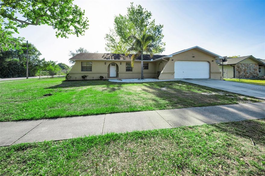 Spacious 3-bedroom, 2-bathroom home featuring laminate flooring throughout with tile in the kitchen and bathrooms. Both the kitchen and baths have been updated, offering a fresh, modern feel. A new roof and AC will be installed prior to closing, providing added peace of mind.

Situated on a large, fully fenced 1/4-acre corner lot, this property offers privacy along with a peaceful creek backdrop. Enjoy outdoor living on the screened-in back porch. The home also features a large 2-car garage and a desirable 3-way split floor plan.

The primary suite includes a walk-in closet and an updated bathroom with dual sinks and a newly remodeled shower.

Conveniently located close to shopping, dining, and all that the area has to offer, with easy access to Tampa International Airport. Low property taxes and NO HOA fees make this an excellent and affordable opportunity.