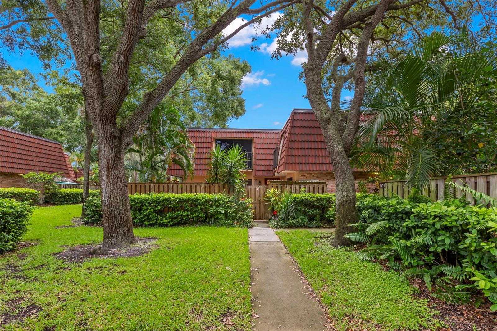 WELCOME TO WEDGE WOOD in Palm Harbor! Step into this beautifully remodeled 2-bedroom, 2.5-bath townhome located in the highly desirable Wedge Wood of Palm Harbor community. Featuring 450 sq. ft. of private, fenced courtyard—perfect for outdoor entertaining, relaxing evenings, or weekend BBQs. The custom-designed kitchen is a chef’s dream with quartz countertops, Maple Cabinets, Stainless steel appliances, and elegant finishes throughout. Enjoy warm gatherings in the spacious living room with built-in wood bookcases and hardwood floors that flow throughout the ground level. The custom vanities in all bathrooms feature Quartz and Corian counters, combining style with functionality. Inside laundry adds everyday convenience. Gorgeous sliders in every room flood the home with natural light and provide seamless access to the outdoors. Enjoy peaceful mornings on one of the two balconies or unwind in the tranquil courtyard. Enjoy resort-style living with beautiful amenities including a heated saltwater community pool, hot tub, tennis and basketball courts, playground, and a serene lake. Located in a NON-FLOOD ZONE! This home also includes two reserved parking spaces plus ample guest parking. Nestled in a tranquil, park-like setting with tree-lined streets, this community is zoned for top-rated schools, and just minutes from Honeymoon Island, Clearwater Beach, Countryside Mall, and some of the area’s best dining and shopping. Don’t miss your chance to own a home that offers comfort, and convenience in one of Palm Harbor’s most sought-after neighborhoods! Call today for your private showing.
