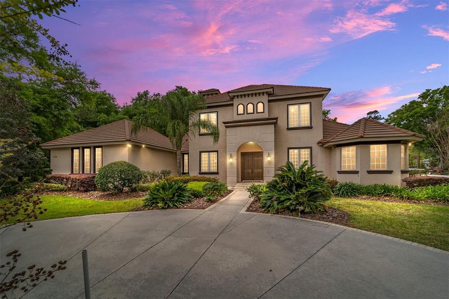 Reintroduced to the market, this exceptional custom estate is located in the distinguished Laurels of Bellechase, one of Ocala’s most sought-after gated communities. Set behind mature landscaping with a circular driveway and tranquil pond views, this 6-bedroom residence offers a refined blend of luxury, comfort, and functionality, just minutes to Downtown Ocala and under 30 minutes to the World Equestrian Center.
Inside, soaring ceilings, expansive windows, and a striking dual-sided fireplace create an impressive yet inviting living space. A private office, dramatic spiral staircase, and seamless indoor-outdoor flow elevate the home’s design.
The primary suite is privately positioned with direct outdoor access, a custom walk-in closet, and a spa-inspired bath featuring a soaking tub, oversized shower, and dual vanities.
The gourmet kitchen opens to the main living area and is designed for entertaining, complete with cherry wood cabinetry, granite countertops, a center island, and gas cooking. Additional guest accommodations, including a private suite, provide flexibility for multi-generational living.
Upstairs, additional bedrooms and a private balcony overlook the backyard, creating a peaceful retreat.
The outdoor living space is the centerpiece, featuring a saltwater pool, covered lanai, and outdoor kitchen, perfect for year-round enjoyment.
Travertine and hardwood flooring (no carpet), plantation shutters, crown molding, and more! 
A rare opportunity to own a move-in ready luxury home in Bellechase, where privacy, location, and lifestyle come together