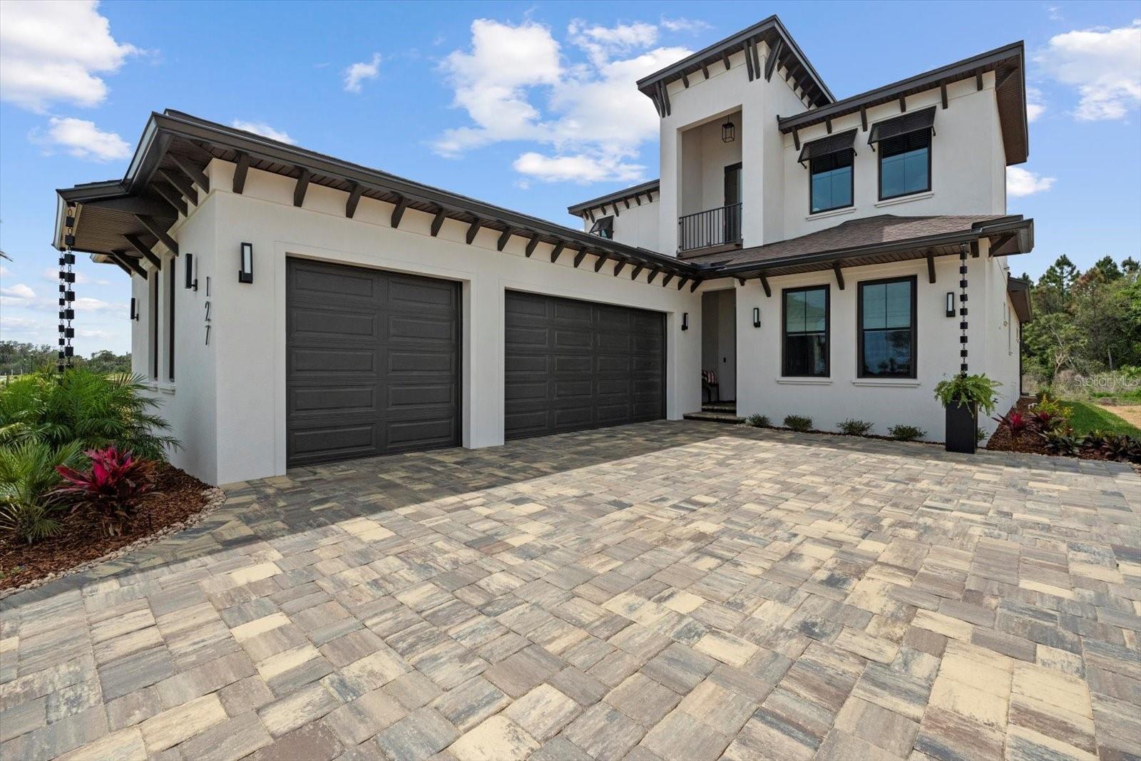 This stunning Hulbert Homes model in Veranda Bay isn’t just beautifully designed—it’s thoughtfully built with purpose and luxury in mind. Every finish, fixture, and layout choice reflects the ease and elegance of coastal living, all set on a spacious 60x130 lot with a heated saltwater pool by Collins Built Pools.
On the main level, you’ll find an open-concept kitchen with a hidden pantry, Matte finish and rose gold accent Cafe Appliances, and a gas stove powered by a buried 250-gallon propane tank—perfect for serious cooks. The living and dining areas flow seamlessly beneath 10-foot ceilings with a custom 8-inch stepped ceiling and inlay detail. Sliders lead out to a peaceful outdoor space ideal for entertaining.
The primary suite is privately tucked off the main living area and includes dual closets, brushed gold fixtures, and a luxurious en suite with a separate soaking tub and shower. A home office and convenient first-floor laundry (with washer and dryer included) round out the downstairs.
Upstairs, enjoy a versatile loft or game room with access to a private balcony, along with two additional bedrooms, a full bath, and a dedicated wine room for that perfect touch of indulgence. You'll also find real wood stairs and landing, LVP and porcelain tile flooring, ventilated wood shelving, and hurricane impact windows and sliders throughout.
This home is currently being used as the builder’s model and includes a 12-month leaseback—giving you the opportunity to secure your future home now while the builder continues to maintain it.
Veranda Bay is a gated waterfront community where golf carts are part of daily life and the Intracoastal is just steps away. Enjoy access to the community pool now, with a future clubhouse, fitness center, and private marina on the way. Shared docks are available between select homesites, with flexible options for ownership and use.
This is more than a home—it’s a lifestyle. Come see it for yourself and start imagining your next chapter in Veranda Bay.