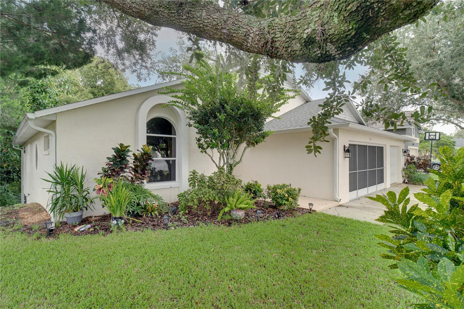 CUSTOM SALTWATER POOL HOME ON HALF-ACRE LOT WITH PRIVATE GARDEN OASIS!
Set on a spacious treed lot backing up to conservation land—with no rear neighbors—this Winter Garden home offers the perfect blend of privacy and charm. Even better, it’s only a five-minute bike ride to Historic Downtown Winter Garden and has a low HOA.
The outdoor space is truly the showstopper: a saltwater pool framed by lush greenery, winding garden paths, a wooden Adirondack swing, and hidden sitting areas. Nearly 1,000 sq. ft. of covered and screened porch space expands the living area outdoors, ideal for entertaining, a man cave, or flexible bonus space.
Inside, the home features Brazilian solid-wood floors, custom cabinetry, granite counters, a stone backsplash, built-in oven/microwave, and display cabinets with under-cabinet lighting. The great room stuns with cathedral beamed ceilings, a gas fireplace, and floor-to-ceiling windows that overlook the gardens.
The primary suite includes vaulted ceilings, a bay window, dual closets, and a spa-style bath with double vanities, garden tub, and separate shower. A secondary bedroom is large enough to serve as a second master. Additional details include wide interior doorways for accessibility, plaster walls, a leaded-glass entry, double-pane insulated windows, and a 16-SEER A/C. The roof, replaced in 2020, is now just about 5 years old, offering peace of mind for years to come.
A transferable termite bond, thoughtful design, and prime location make this home a standout in Winter Garden.