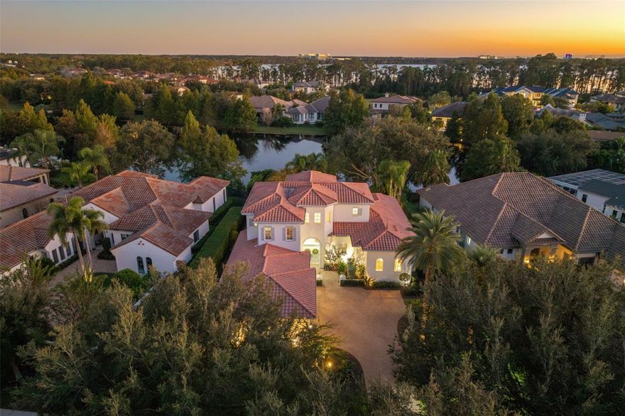 Built in 2012 by renowned ISSA Homes, this exquisite residence has been meticulously maintained and thoughtfully updated throughout. Set on one-third of an acre overlooking a tranquil pond, the home spans nearly 5,100 square feet and features five en-suite bedrooms, a powder bath, a dedicated office, an upstairs loft, and a three-car garage.
The outdoor living is truly exceptional, recently reimagined with new Travertine pavers, updated pool tile and interior finish, lush tropical landscaping, and a freshly painted exterior. Enjoy a private pool and spa, expansive sun deck, and a covered lanai complete with summer kitchen and remote-controlled shade screens—perfect for both relaxing and entertaining.
Inside, new double front doors open to a home filled with natural light, soaring ceilings, and travertine floors with intricate wood inlays. The main level offers elegant living and entertaining spaces, including a formal living room with a gas fireplace and coffered ceiling accented by designer wallpaper, a bright dining room with a statement chandelier, a cozy family room overlooking the lush landscaping and pond, a private office with custom built-ins, and a gourmet kitchen showcasing light blue cabinetry, new stone countertops, a butcher block island, and designer lighting throughout.
On the first floor, the primary suite is a serene retreat featuring a breakfast bar, three closets, and a luxurious bath with a walk-through shower, dual vanities, and a garden tub. A secondary bedroom suite, powder bath, and utility room complete the main level.
Upstairs, a spacious loft anchors three additional bedroom suites, each with its own fully renovated bath, providing comfort and privacy for family or guests.
Nestled within the gated Lake Nona Golf & Country Club, residents enjoy 24-hour security, A-rated schools, and close proximity to Orlando International Airport, Medical City, Boxi Park, fine dining, shopping, and major expressways (417 Greenway and 528 Beachline) for convenient access throughout Central Florida.
This move-in-ready home perfectly blends timeless craftsmanship, elegant updates, and the very best in Country Club living.