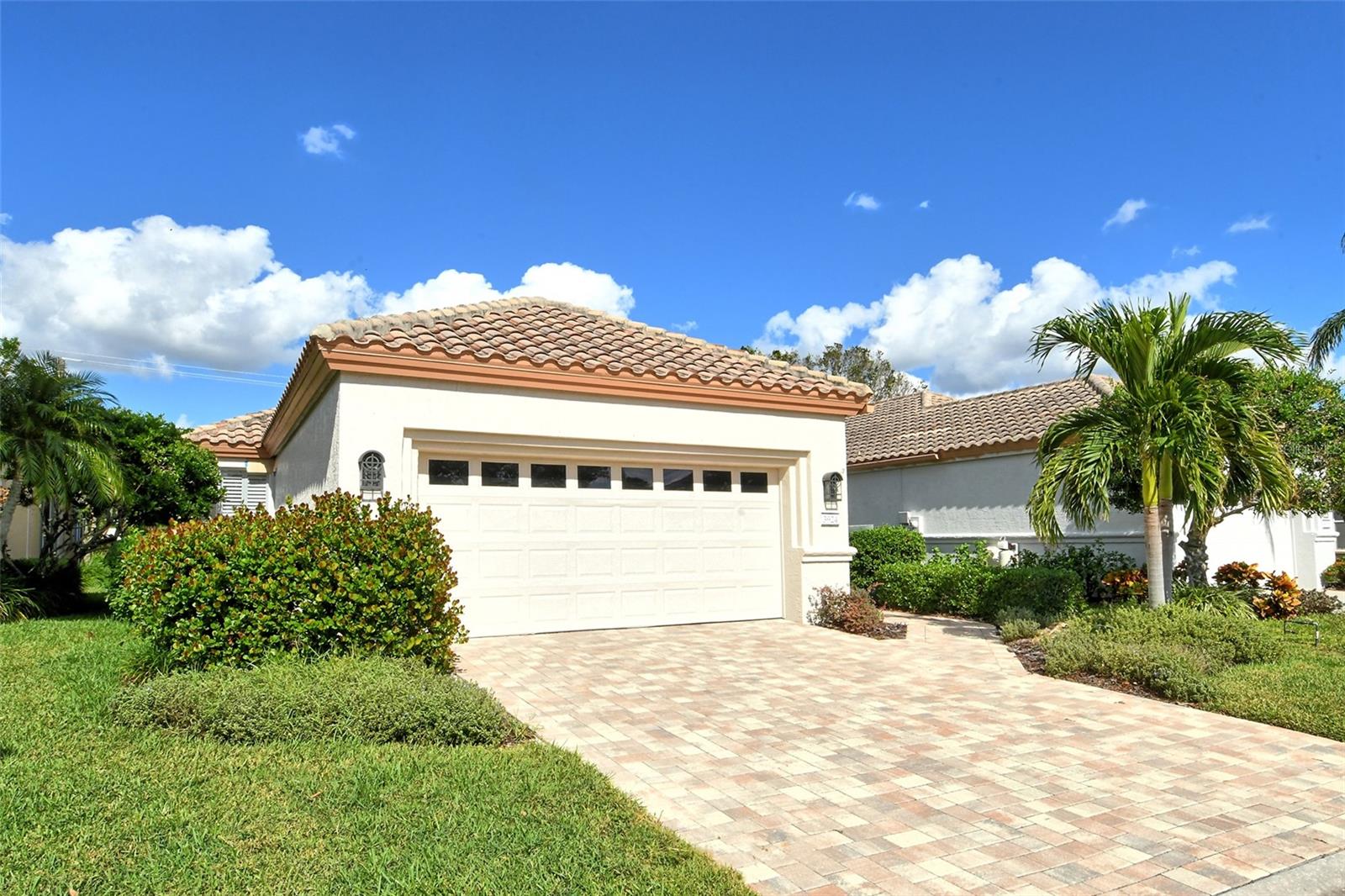 Motivated Seller! Quick close. Spend the remainder of your winter in Sunny Sarasota! Discover one of Sarasota's most elegantly landscaped and secluded gated communities, Mira Lago, in Palmer Ranch. This maintenance-free, boutique community is the epitome of serene luxury. Built in phase three, this home offers tranquil lake views and boasts two bedrooms, two baths, and a beautifully glass-enclosed and screened lanai. Step outside to the expansive 32-by-22-foot exterior lanai featuring a sleek epoxy floor, a remote-controlled pergola with independently adjustable power screens, louvers and LED lighting, offering an array of customizable screen and ceiling coverage options. Enjoy your outdoor living space with unobstructed lake views in every season. Designed with a contemporary flair, this residence showcases luxury vinyl flooring in both bedrooms and refined tile throughout the main living areas. The kitchen is a chef’s dream, adorned with granite countertops, high-gloss lacquer cabinets with soft-close drawers, up-lighting and a new refrigerator. Soaring ceilings and a fresh color palette enhance the home's bright, airy ambiance, making it must-see. Both baths feature comfort-height toilets, while recent upgrades throughout the home include energy-efficient LED lighting, replacement of both screen doors, a driveway and walkway, an upgraded alarm system, a Ring doorbell, MyQ garage door system, epoxy-finished garage flooring, custom storage cabinets and a landline with 24-hour backup battery. Maintenance covers all lawn care, including mowing, fertilizing, irrigation, mulching, dead plant replacement, tree and shrub trimming, power washing of sidewalks, driveways, roof, and interior and exterior pest control. The community paints the exterior every 10 years and has a color palette of five colors to choose from. Community amenities include a heated pool and spa, gated access, a part-time maintenance attendant, and basic cable through Frontier. Embrace an active lifestyle with easy access to Legacy Trail, ideal for biking or walking, and enjoy nearby Gulf Coast beaches, Costco, shopping and fine dining just a short drive away. This pristine, move-in-ready home offers a rare opportunity to immerse yourself in Sarasota’s vibrant arts and culture scene. View the virtual tour and schedule your visit today!